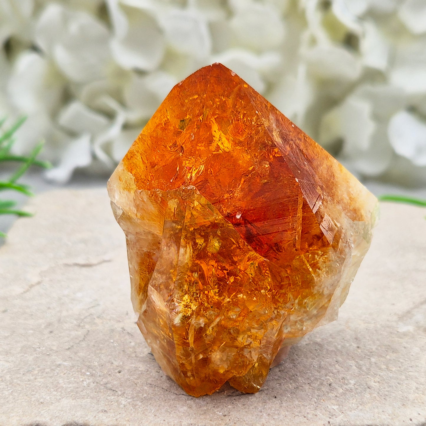 Citrine crystal standing point from Brazil with a polished tip and natural sides. Associated with confidence, motivation, positivity, and personal growth.