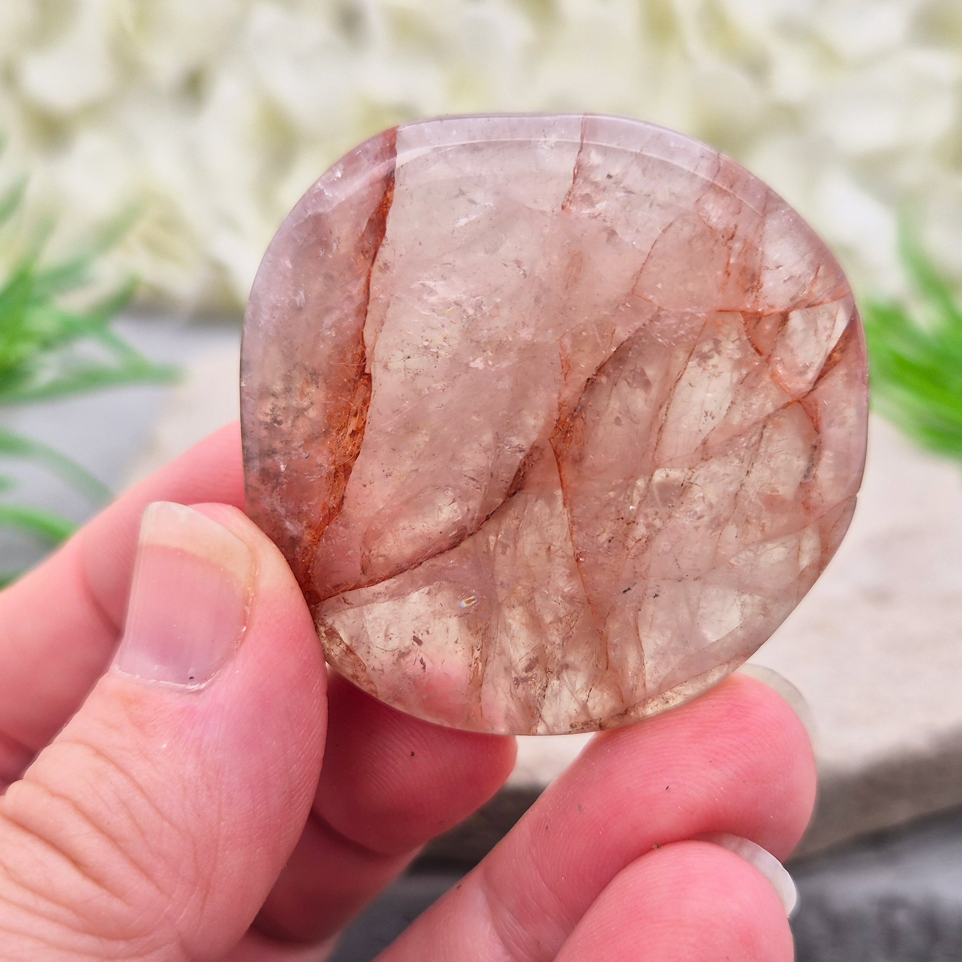 Shop this natural Crimson Healer Palm Stone with beautiful rainbows and Hematite inclusions. A grounding crystal for confidence, focus and balance.