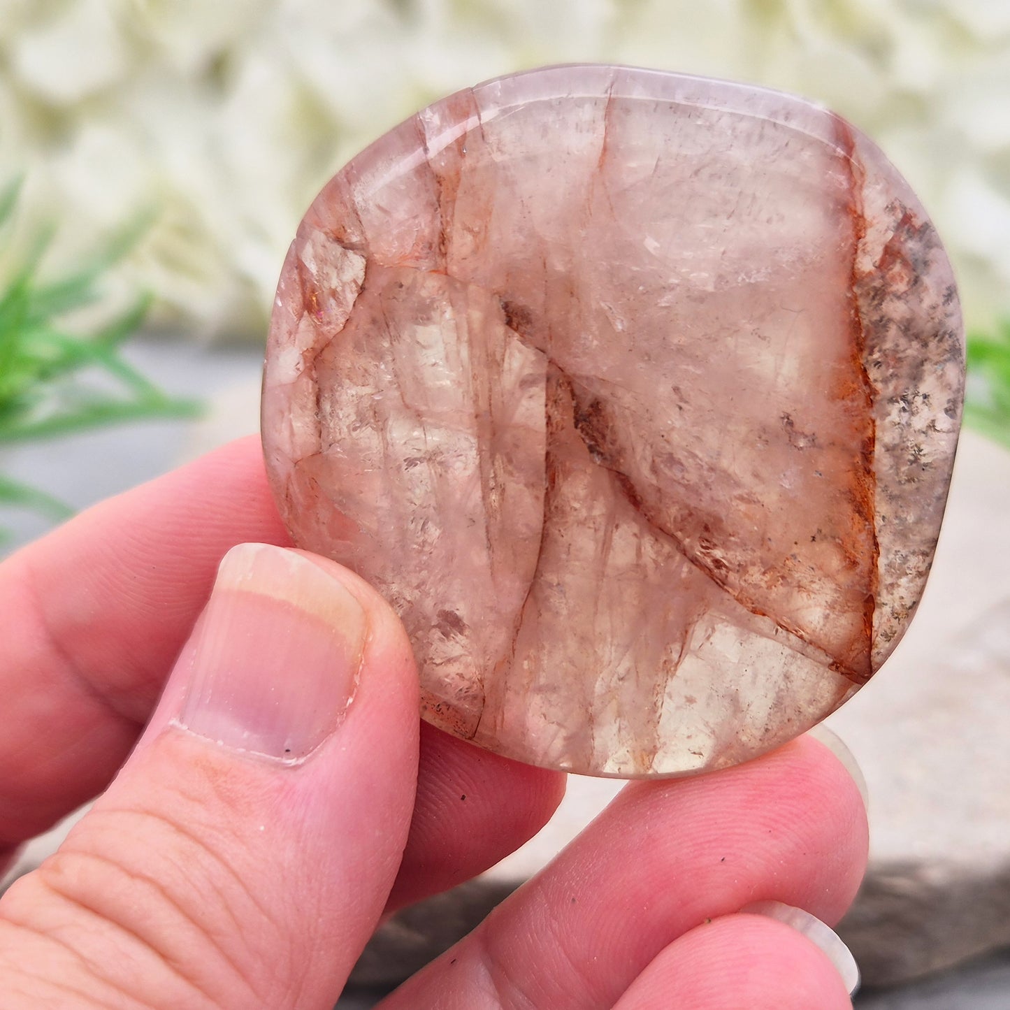 Shop this natural Crimson Healer Palm Stone with beautiful rainbows and Hematite inclusions. A grounding crystal for confidence, focus and balance.