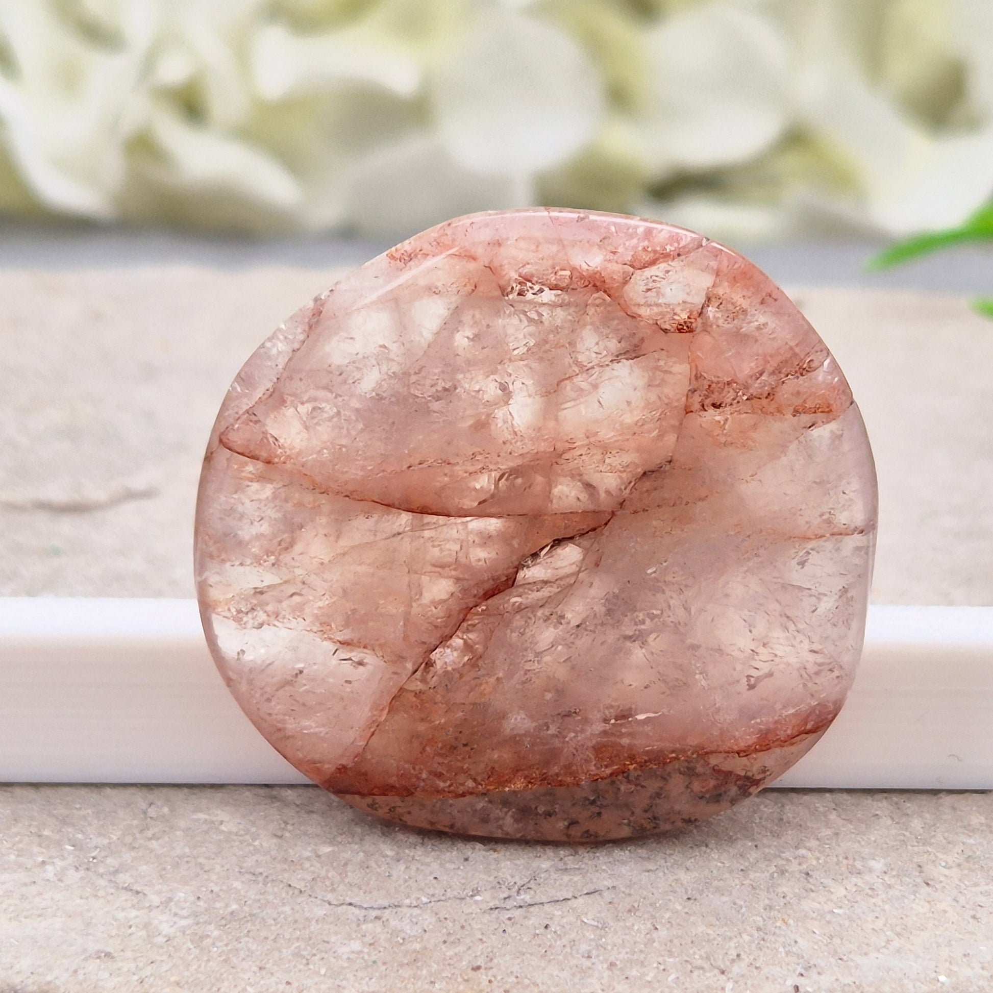 Shop this natural Crimson Healer Palm Stone with beautiful rainbows and Hematite inclusions. A grounding crystal for confidence, focus and balance.