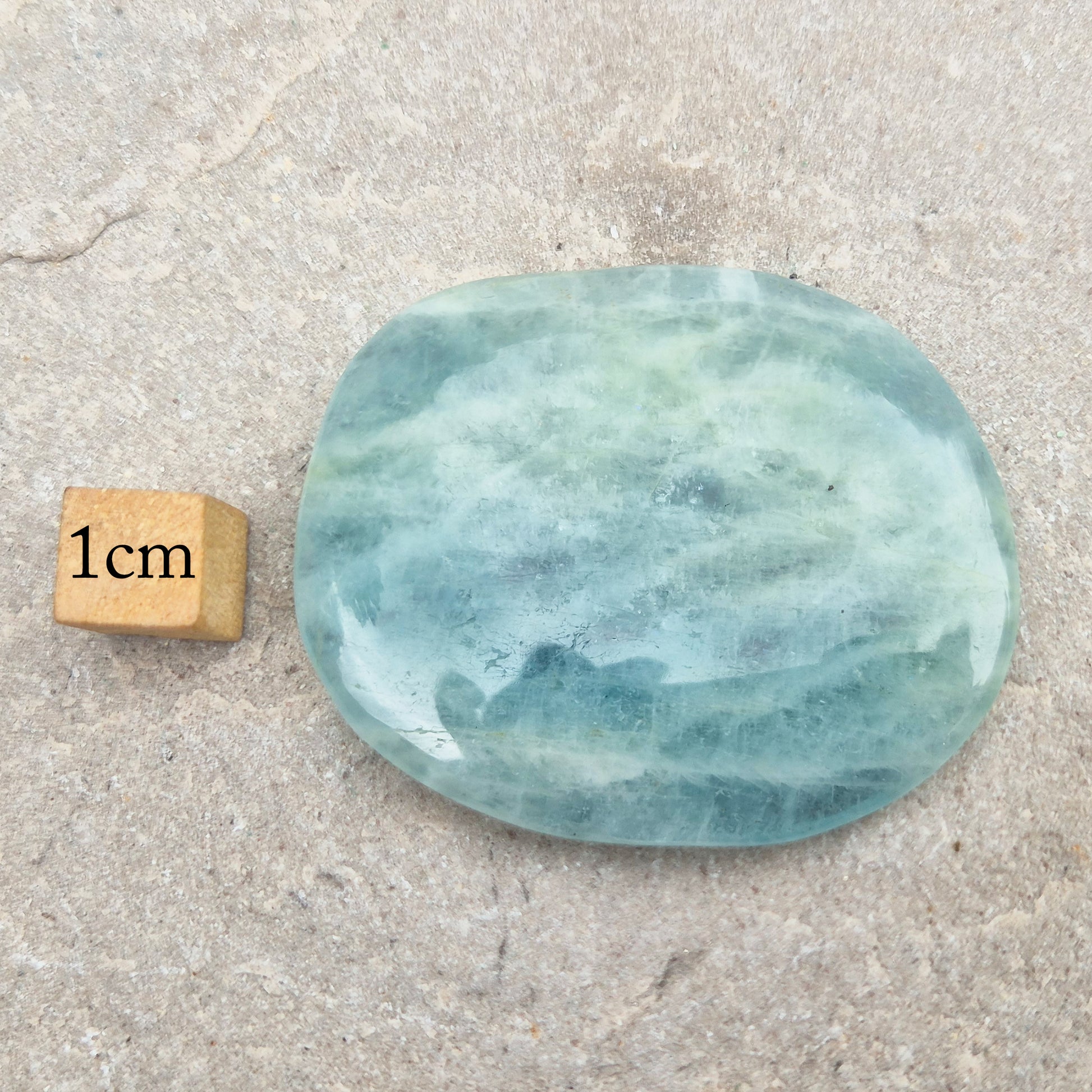 Shop polished Aquamarine palm stones — calming, water-toned crystals known for supporting clear communication. A thoughtful gift for anyone facing a stressful time.