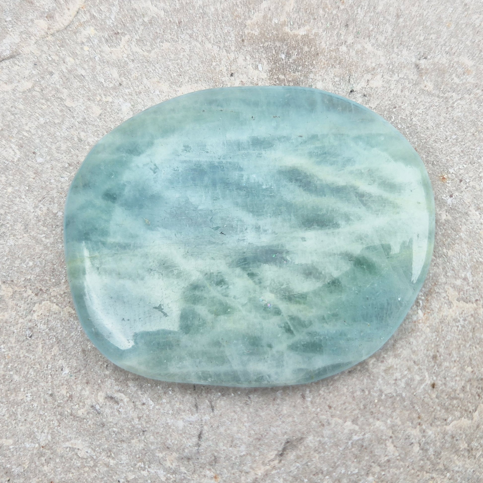 Shop polished Aquamarine palm stones — calming, water-toned crystals known for supporting clear communication. A thoughtful gift for anyone facing a stressful time.