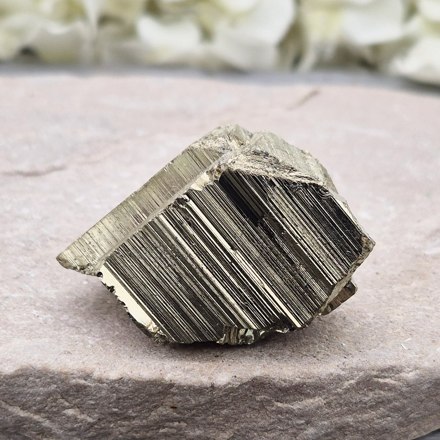 Pyrite specimen with striated face and bright metallic shine. Sparkling smooth and natural texture, ideal for display, grounding energy, or crystal collections.
