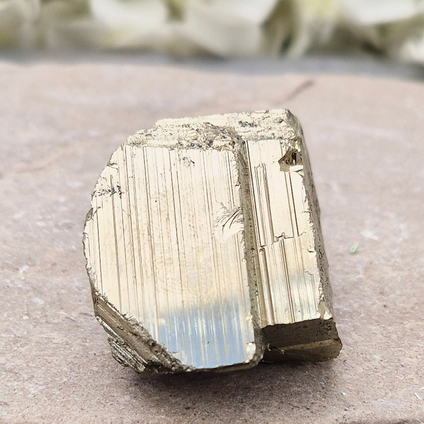Pyrite specimen with striated face and bright metallic shine. Sparkling smooth and natural texture, ideal for display, grounding energy, or crystal collections.