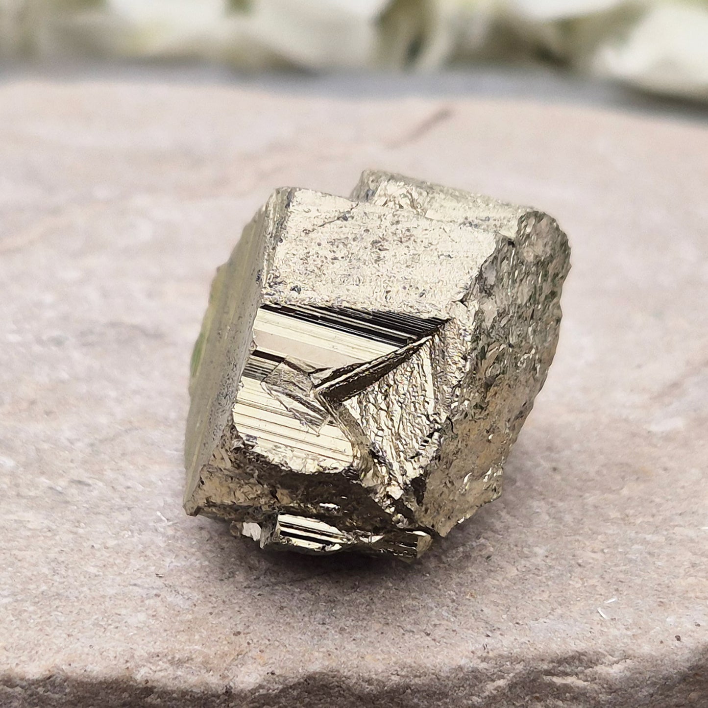 Pyrite specimen with striated face and bright metallic shine. Sparkling smooth and natural texture, ideal for display, grounding energy, or crystal collections.