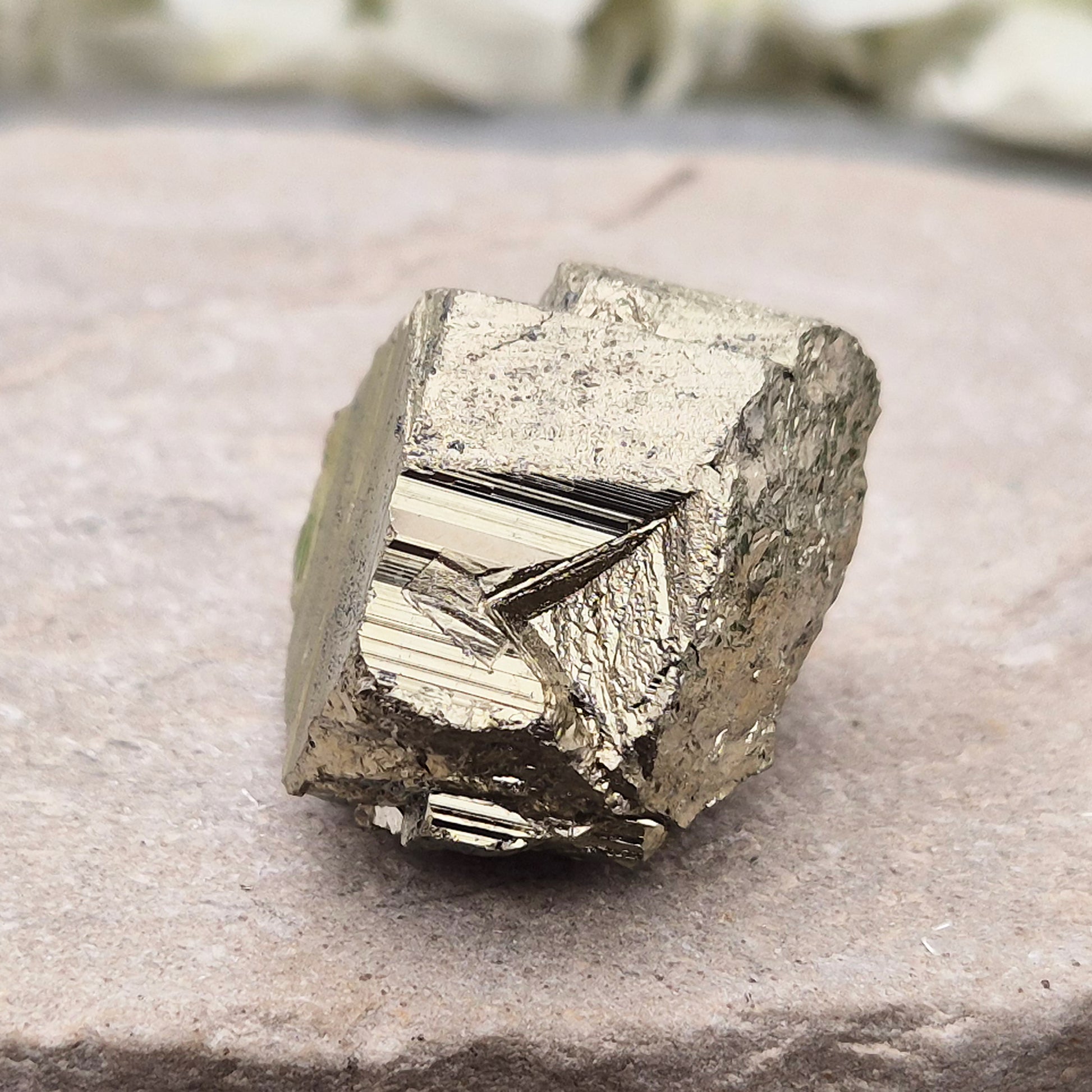 Pyrite specimen with striated face and bright metallic shine. Sparkling smooth and natural texture, ideal for display, grounding energy, or crystal collections.