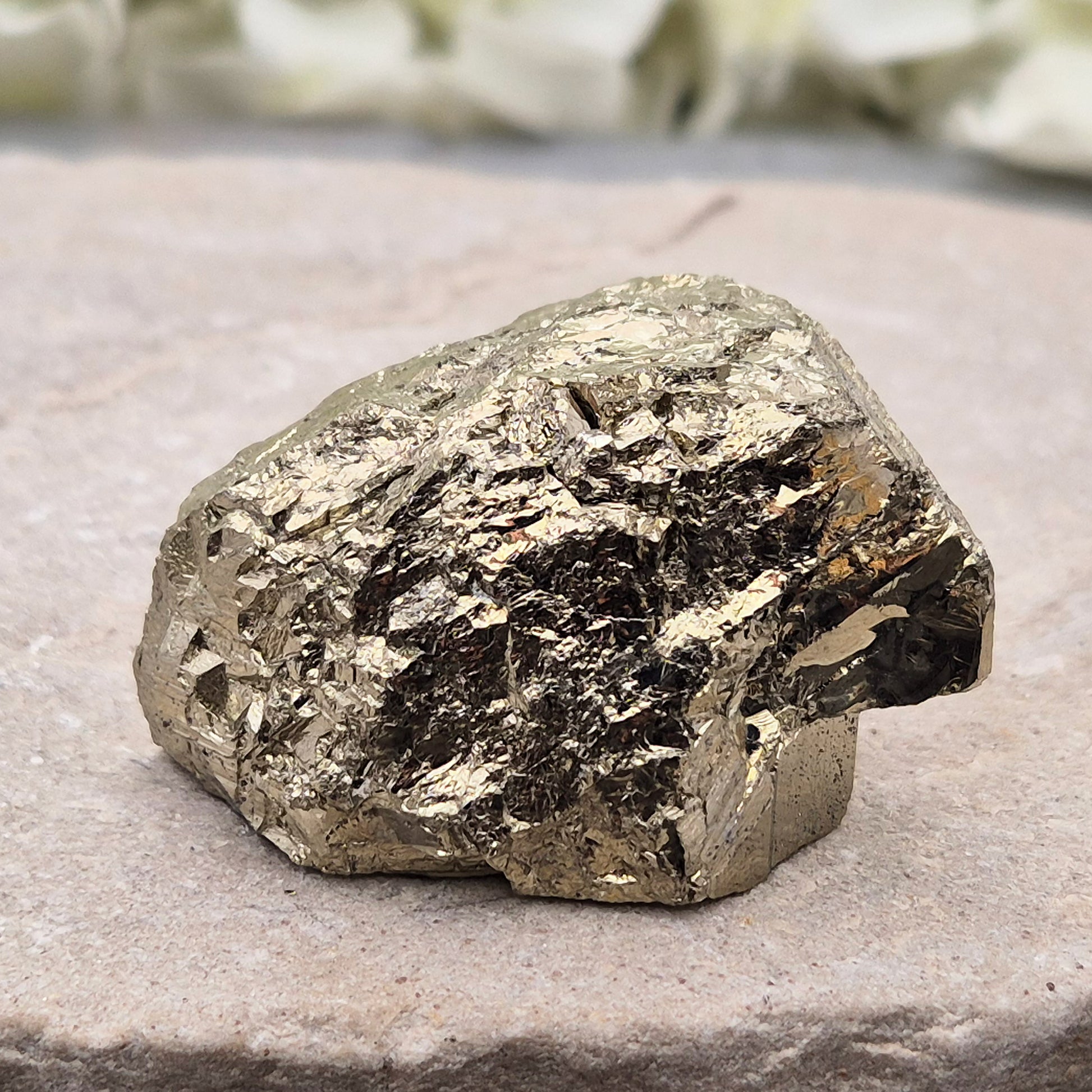 Pyrite specimen with striated face and bright metallic shine. Sparkling smooth and natural texture, ideal for display, grounding energy, or crystal collections.