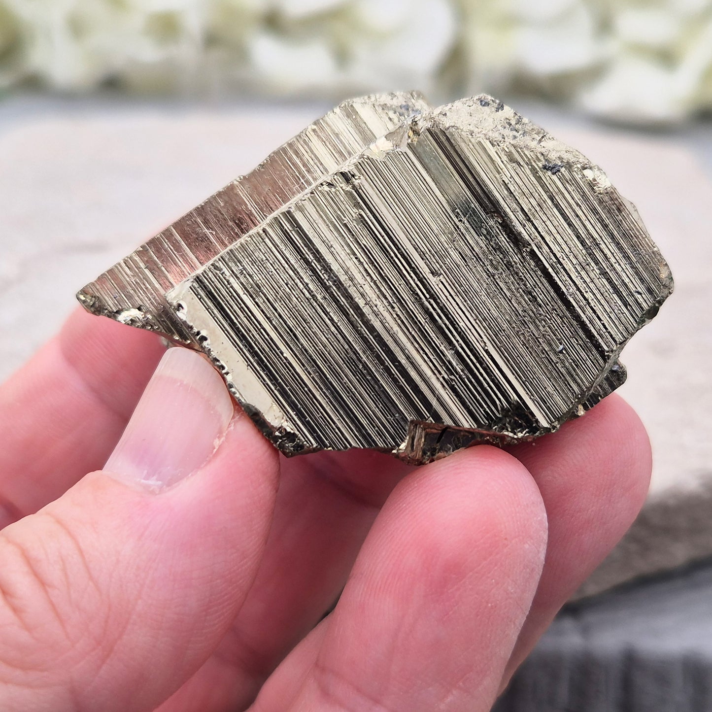 Pyrite specimen with striated face and bright metallic shine. Sparkling smooth and natural texture, ideal for display, grounding energy, or crystal collections.