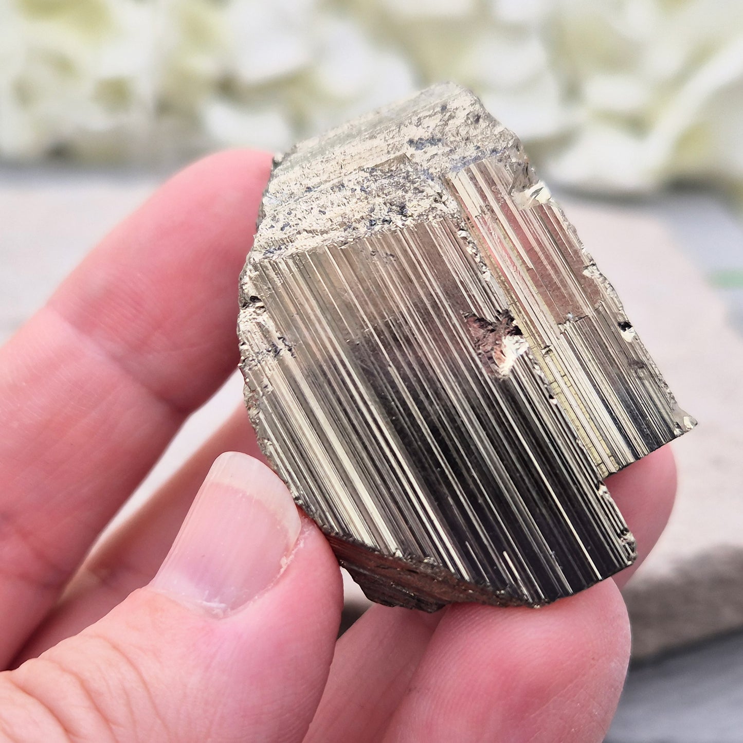Pyrite specimen with striated face and bright metallic shine. Sparkling smooth and natural texture, ideal for display, grounding energy, or crystal collections.
