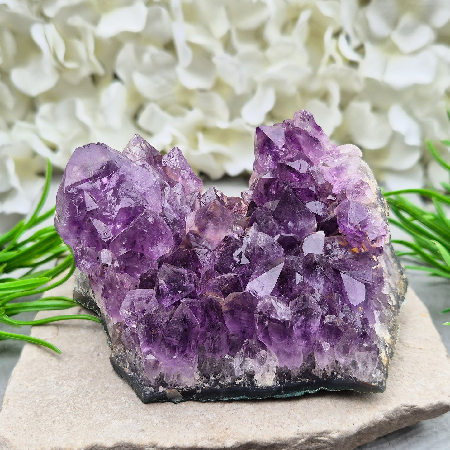 A grade Brazilian Amethyst cluster with deep purple points. A calming crystal for peaceful home spaces, bedrooms, and thoughtful crystal gifts.