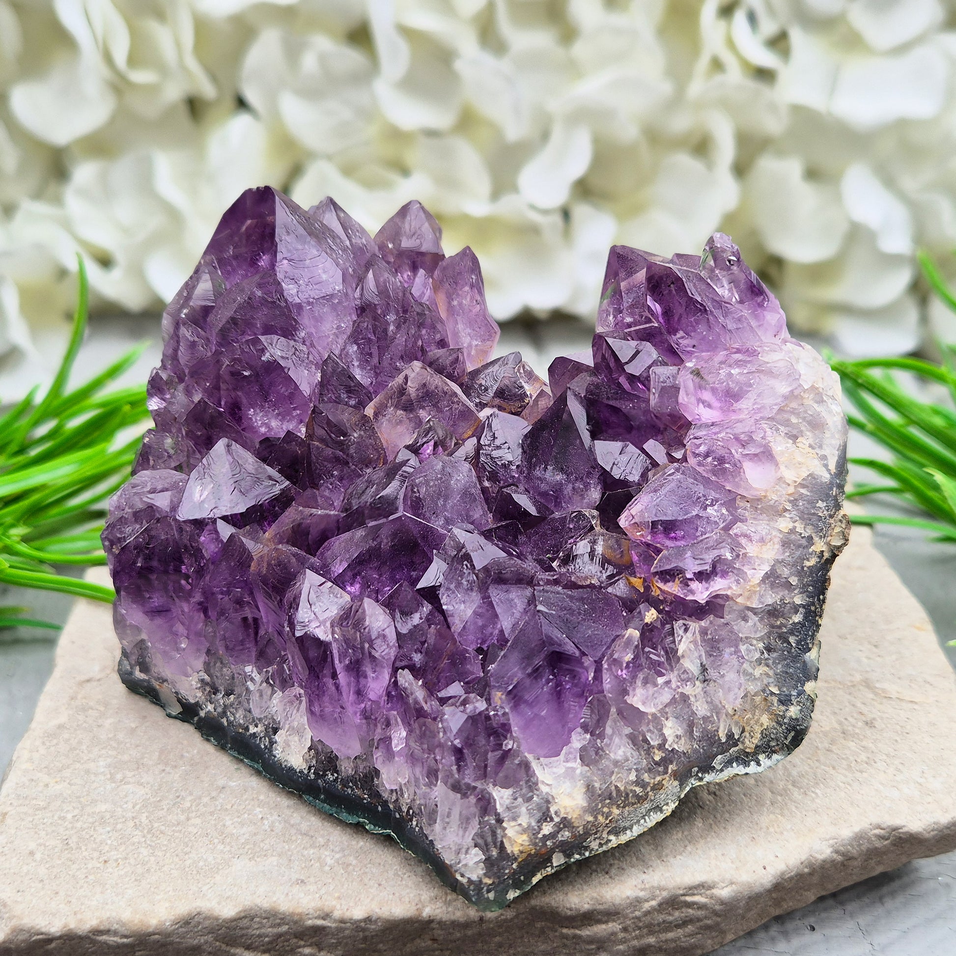 A grade Brazilian Amethyst cluster with deep purple points. A calming crystal for peaceful home spaces, bedrooms, and thoughtful crystal gifts.