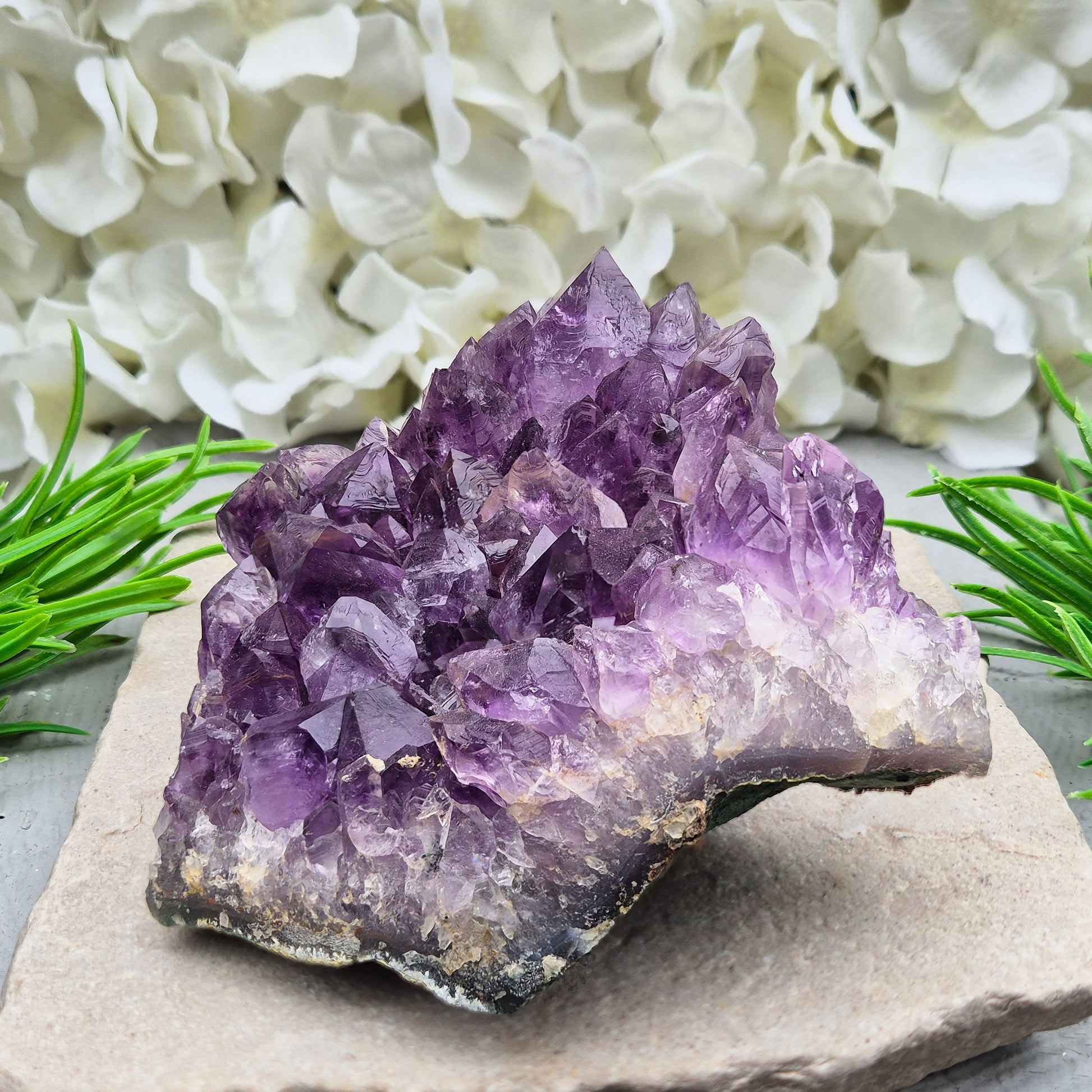 A grade Brazilian Amethyst cluster with deep purple points. A calming crystal for peaceful home spaces, bedrooms, and thoughtful crystal gifts.
