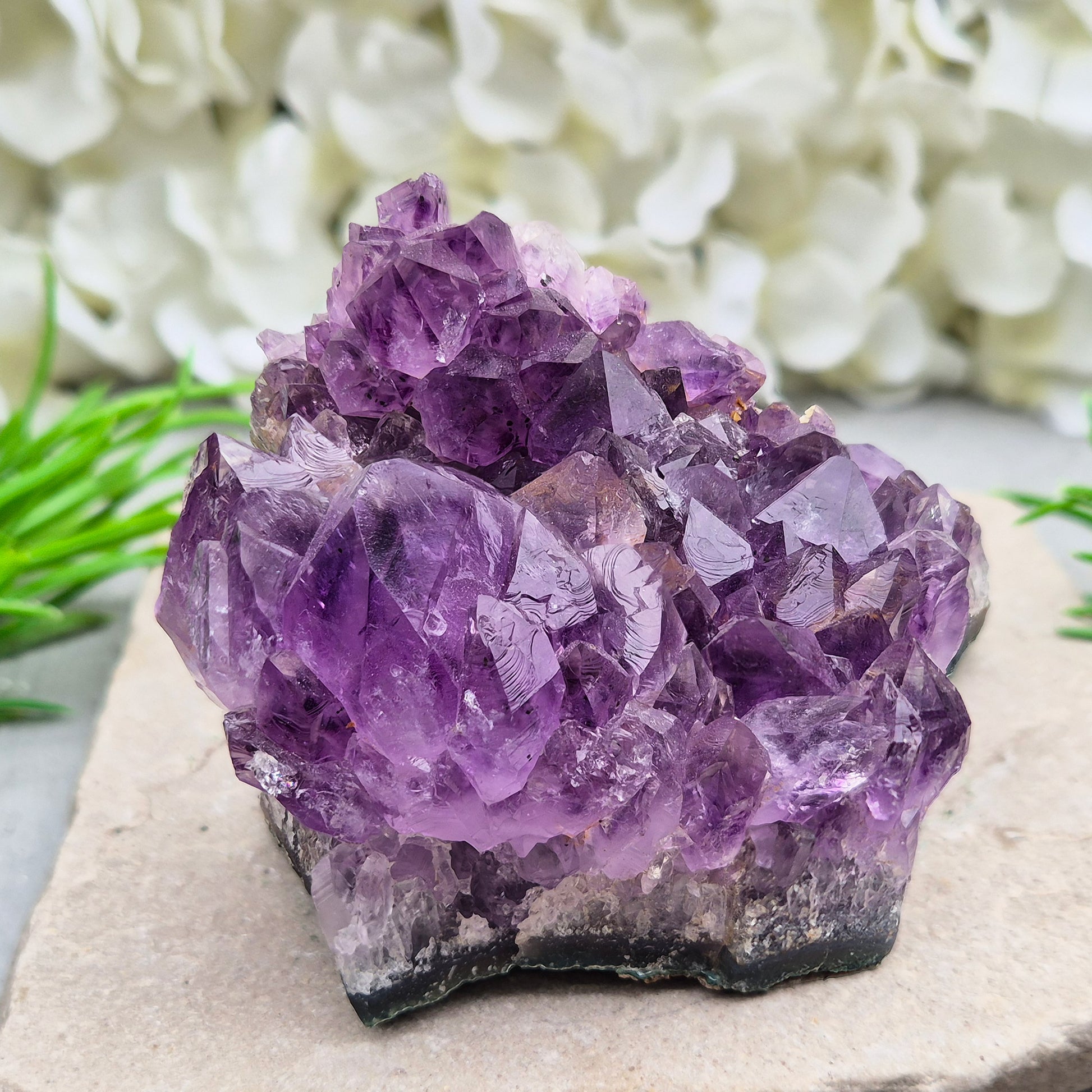 A grade Brazilian Amethyst cluster with deep purple points. A calming crystal for peaceful home spaces, bedrooms, and thoughtful crystal gifts.