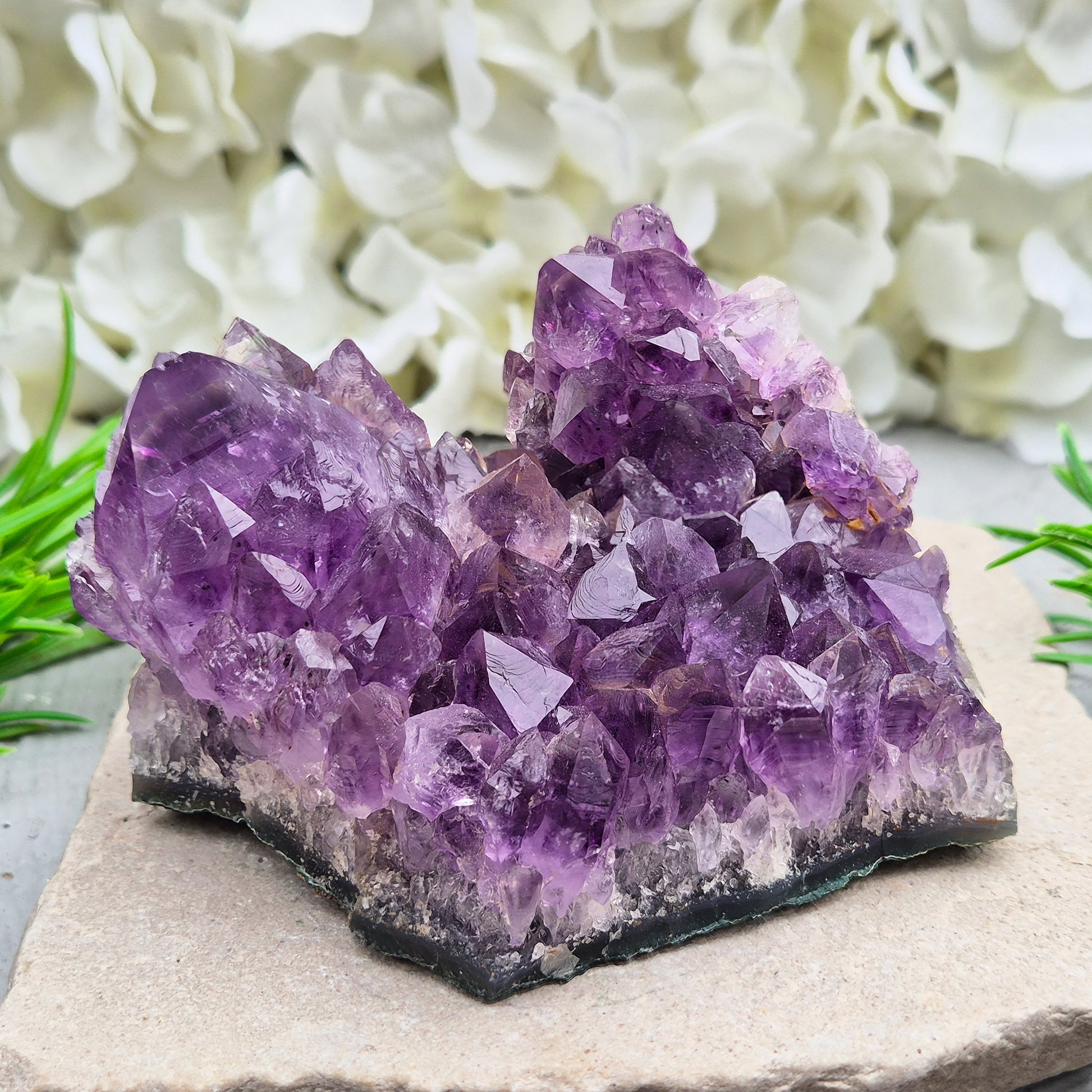 A grade Brazilian Amethyst cluster with deep purple points. A calming crystal for peaceful home spaces, bedrooms, and thoughtful crystal gifts.