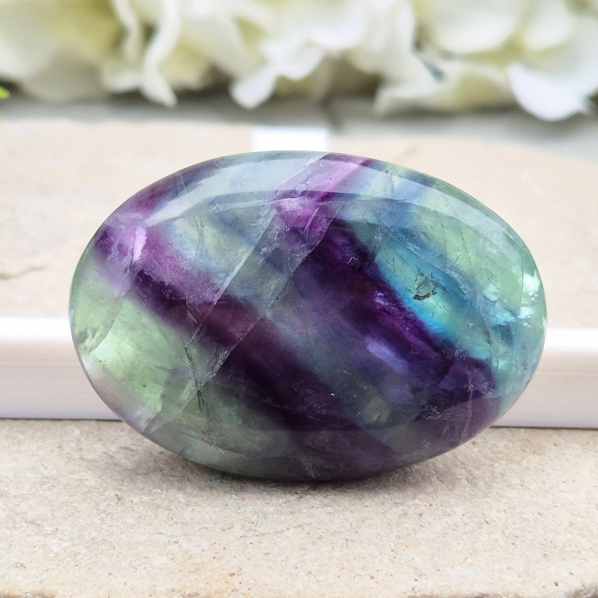 Fluorite palm stone in green, purple & blue. Supports focus, mental balance, and calm energy. Perfect for holding, meditation, or gifting. 