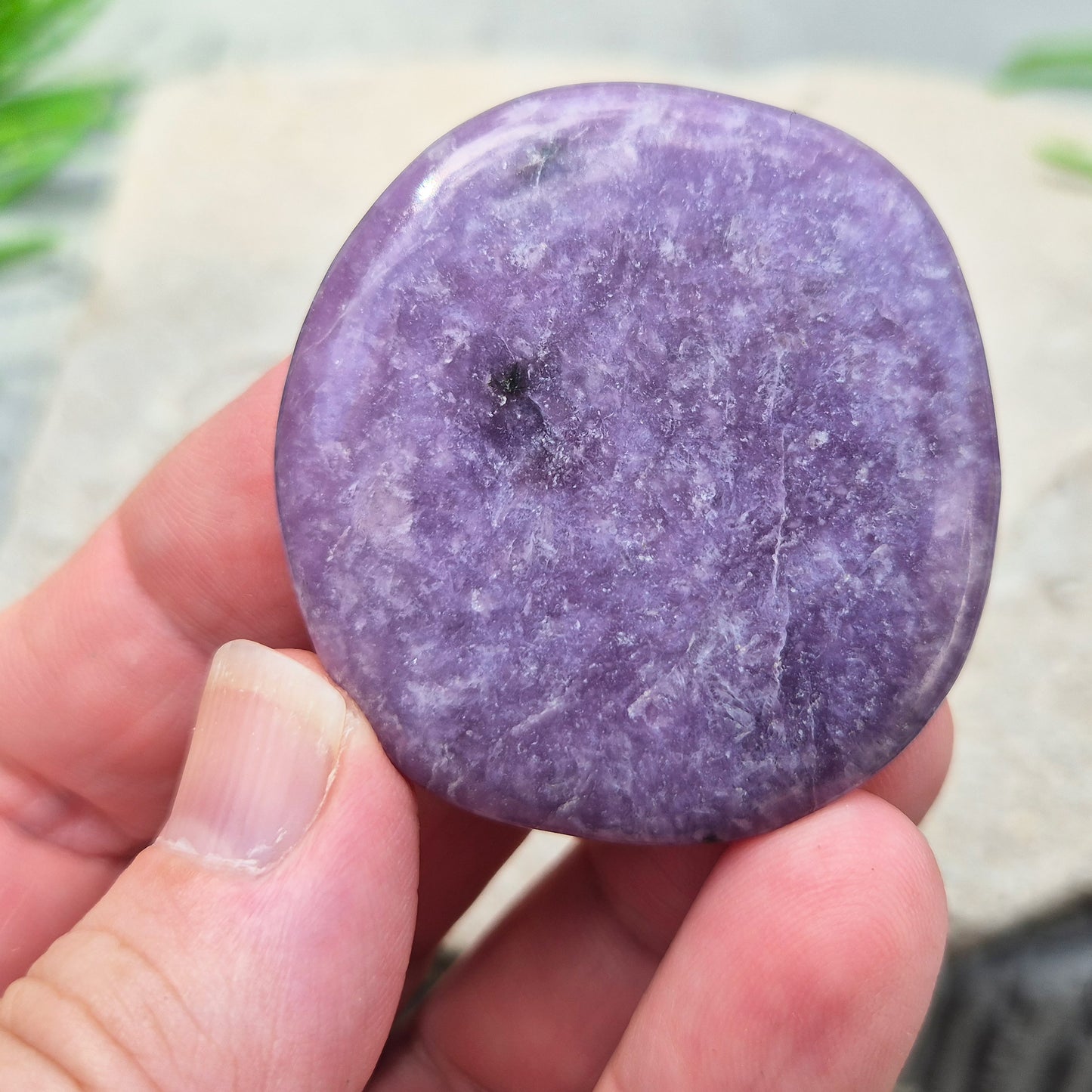 Lepidolite palm stone with calming, balancing energy. Known for easing stress and emotional overwhelm. Smooth, soothing, and ideal for daily support.