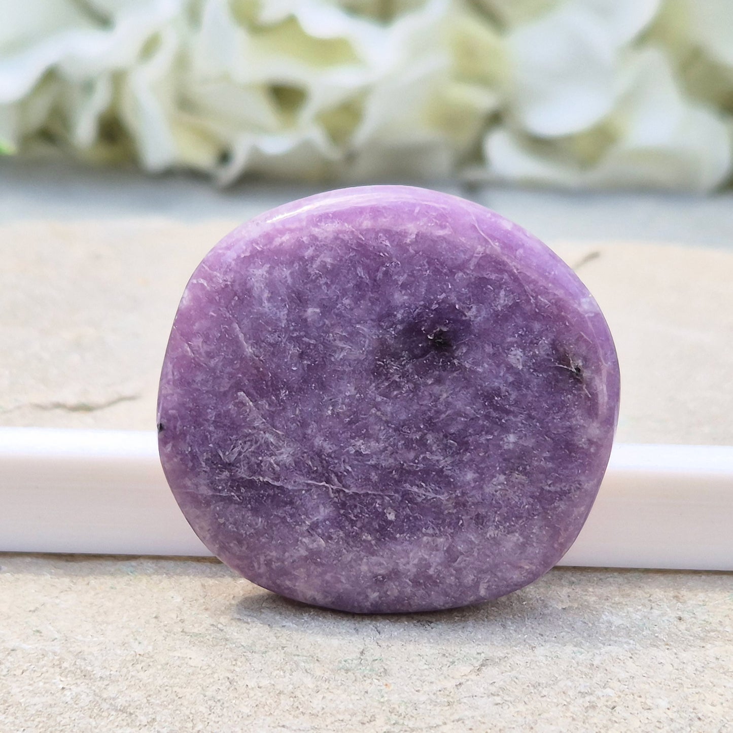 Lepidolite palm stone with calming, balancing energy. Known for easing stress and emotional overwhelm. Smooth, soothing, and ideal for daily support.