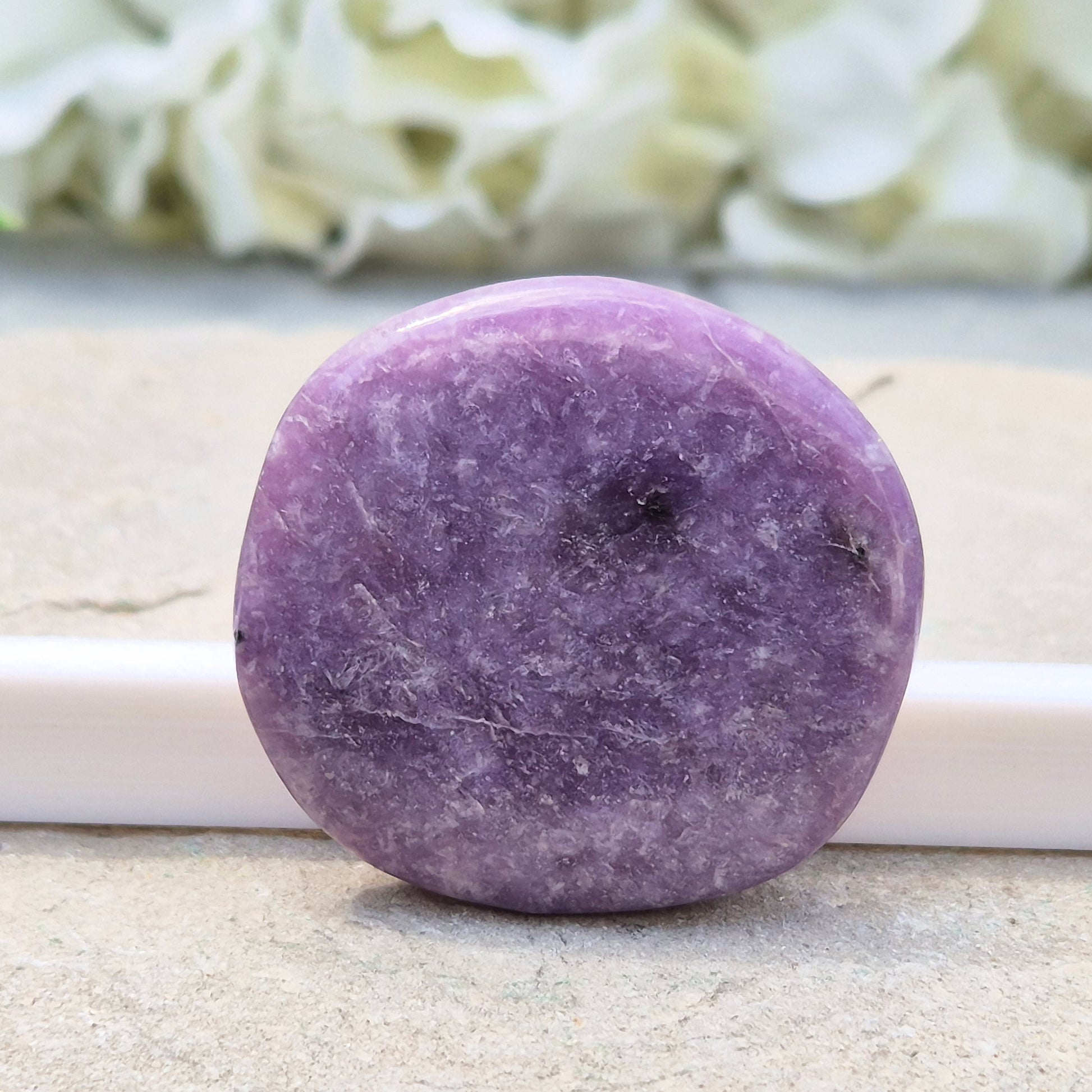 Lepidolite palm stone with calming, balancing energy. Known for easing stress and emotional overwhelm. Smooth, soothing, and ideal for daily support.