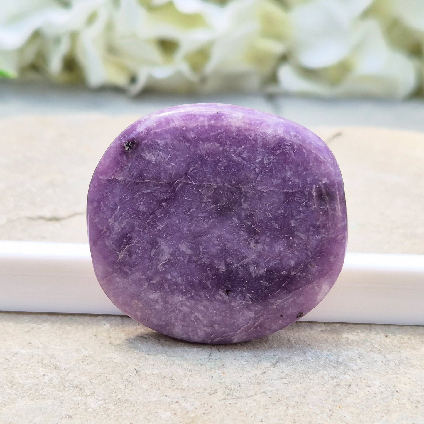 Lepidolite palm stone with calming, balancing energy. Known for easing stress and emotional overwhelm. Smooth, soothing, and ideal for daily support.
