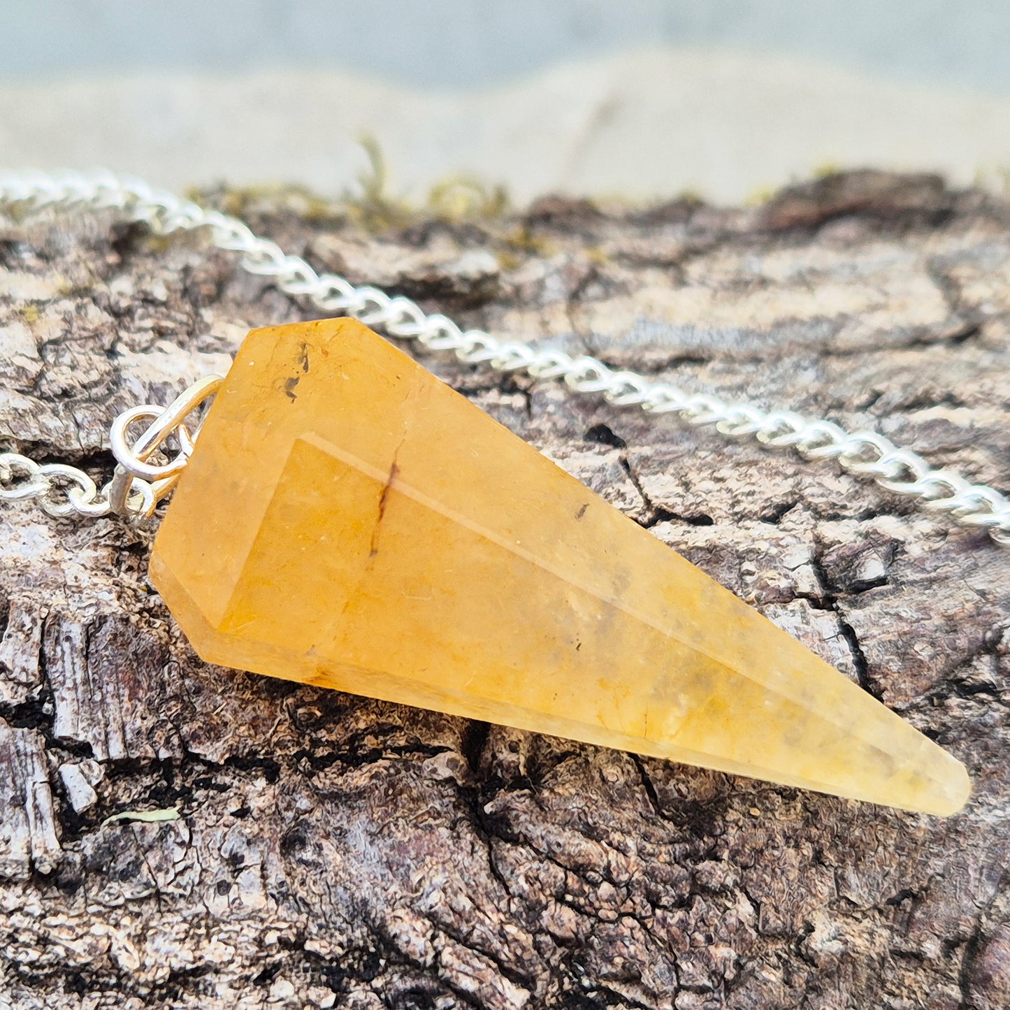 Golden Healer Quartz pendulum for dowsing and energy work. Supports clarity, balance, healing, and connection to higher guidance. 