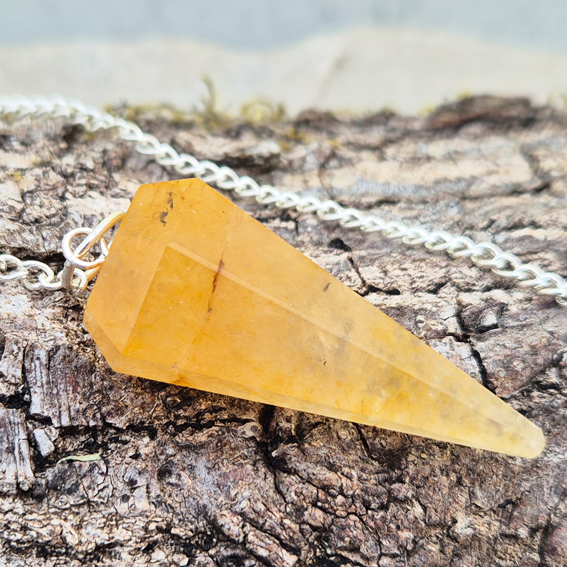 Golden Healer Quartz pendulum for dowsing and energy work. Supports clarity, balance, healing, and connection to higher guidance. 