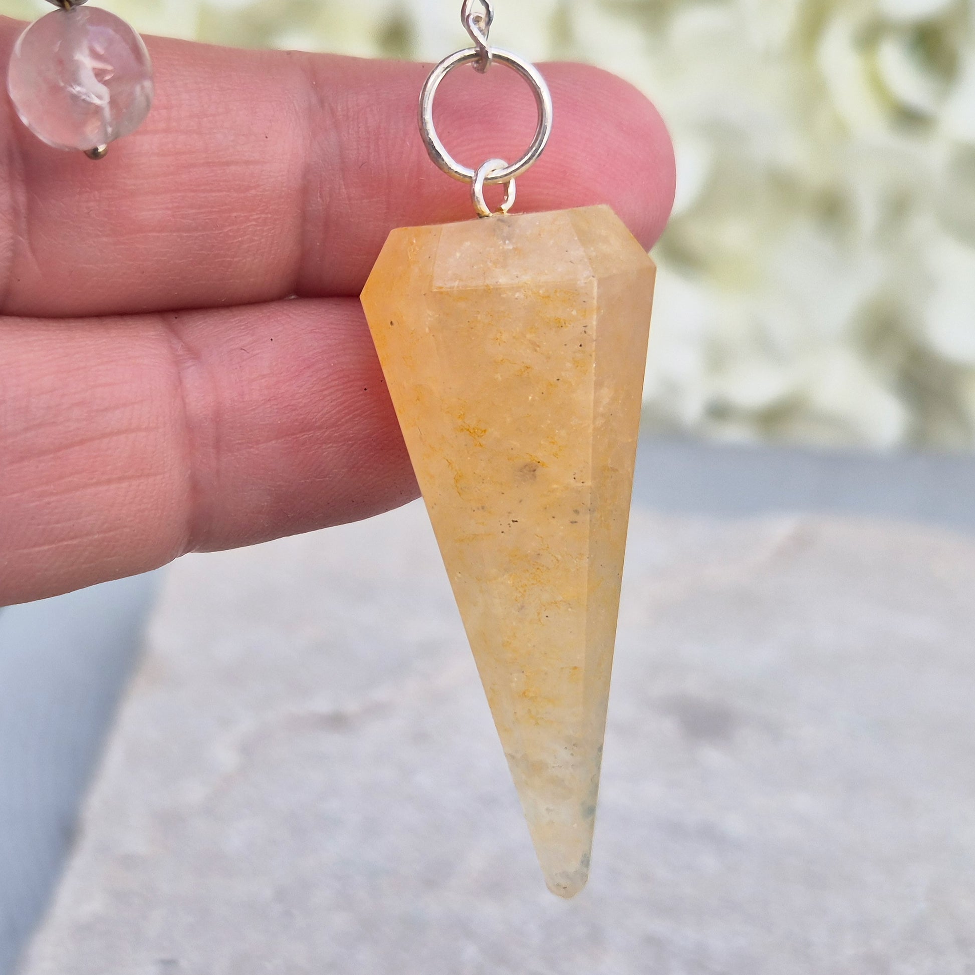 Golden Healer Quartz pendulum for energy work, dowsing, and intuitive guidance. Connects to gentle healing, balance, and spiritual growth.