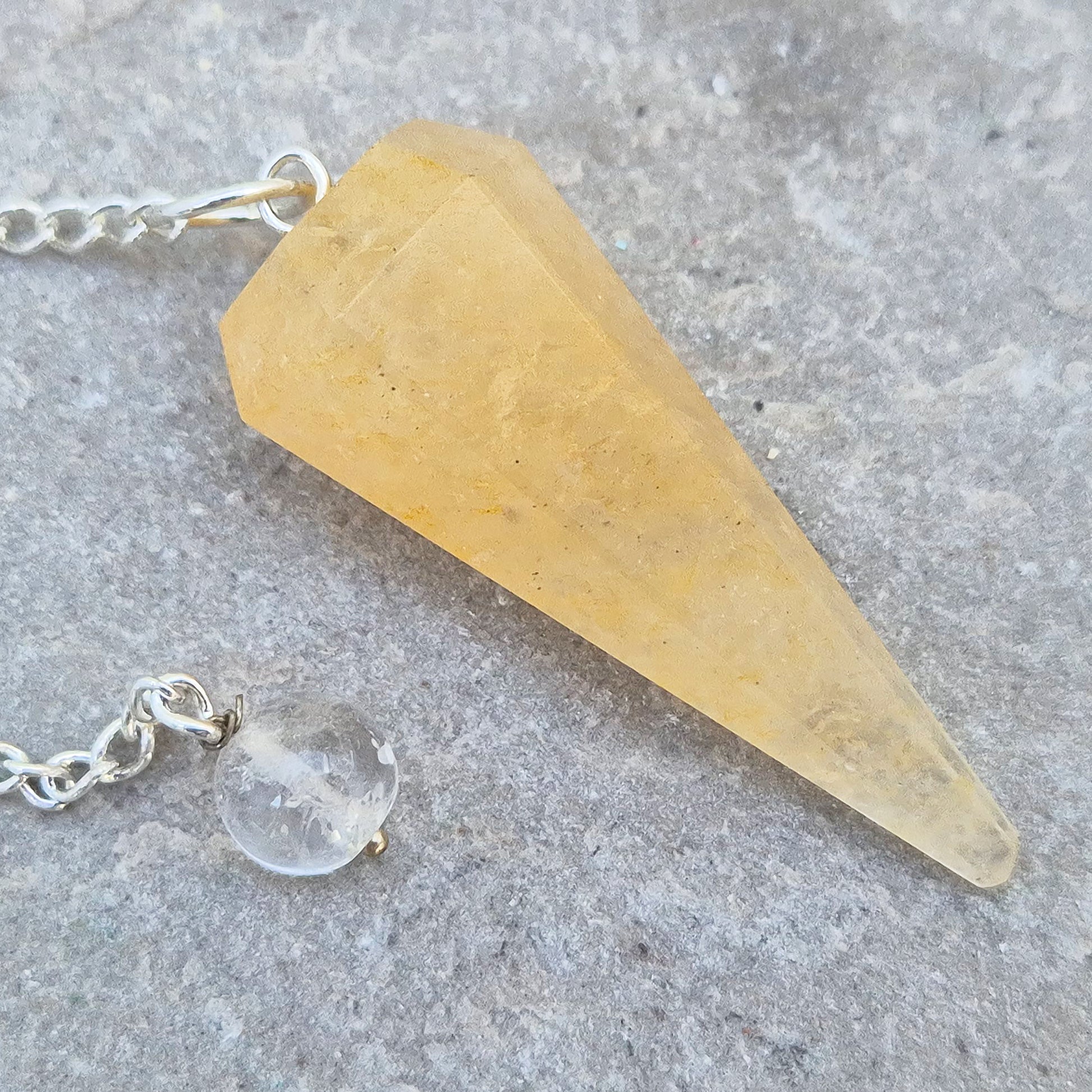 Golden Healer Quartz pendulum for energy work, dowsing, and intuitive guidance. Connects to gentle healing, balance, and spiritual growth.