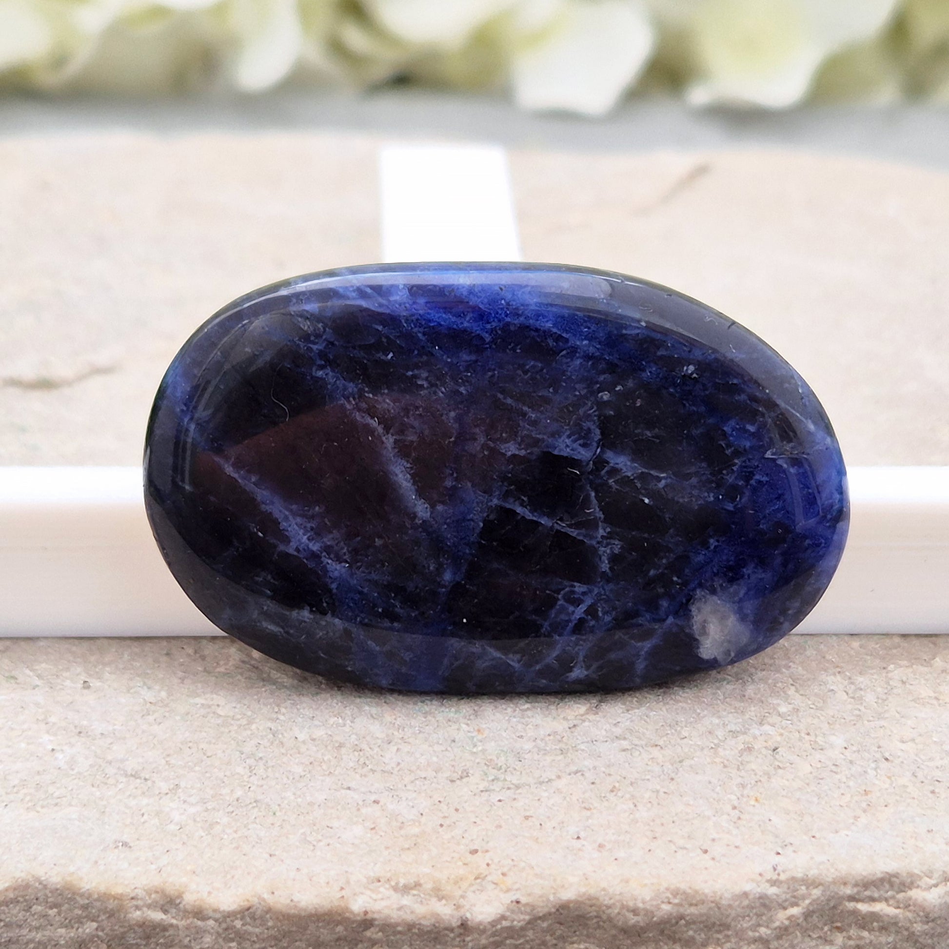 Beautiful A-grade Sodalite palm stone from Namibia. Supports clear thinking, confidence in communication, and emotional calm. Throat & Third Eye chakra crystal.