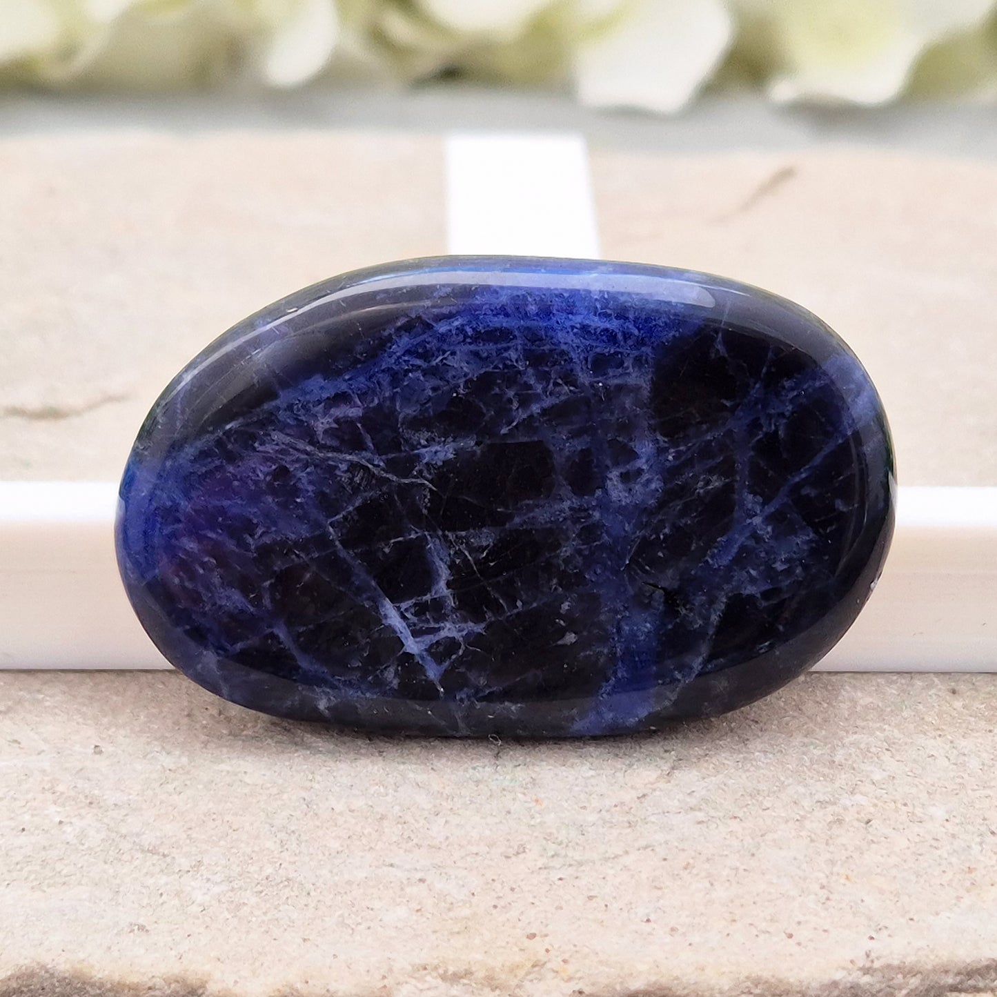 Beautiful A-grade Sodalite palm stone from Namibia. Supports clear thinking, confidence in communication, and emotional calm. Throat & Third Eye chakra crystal.