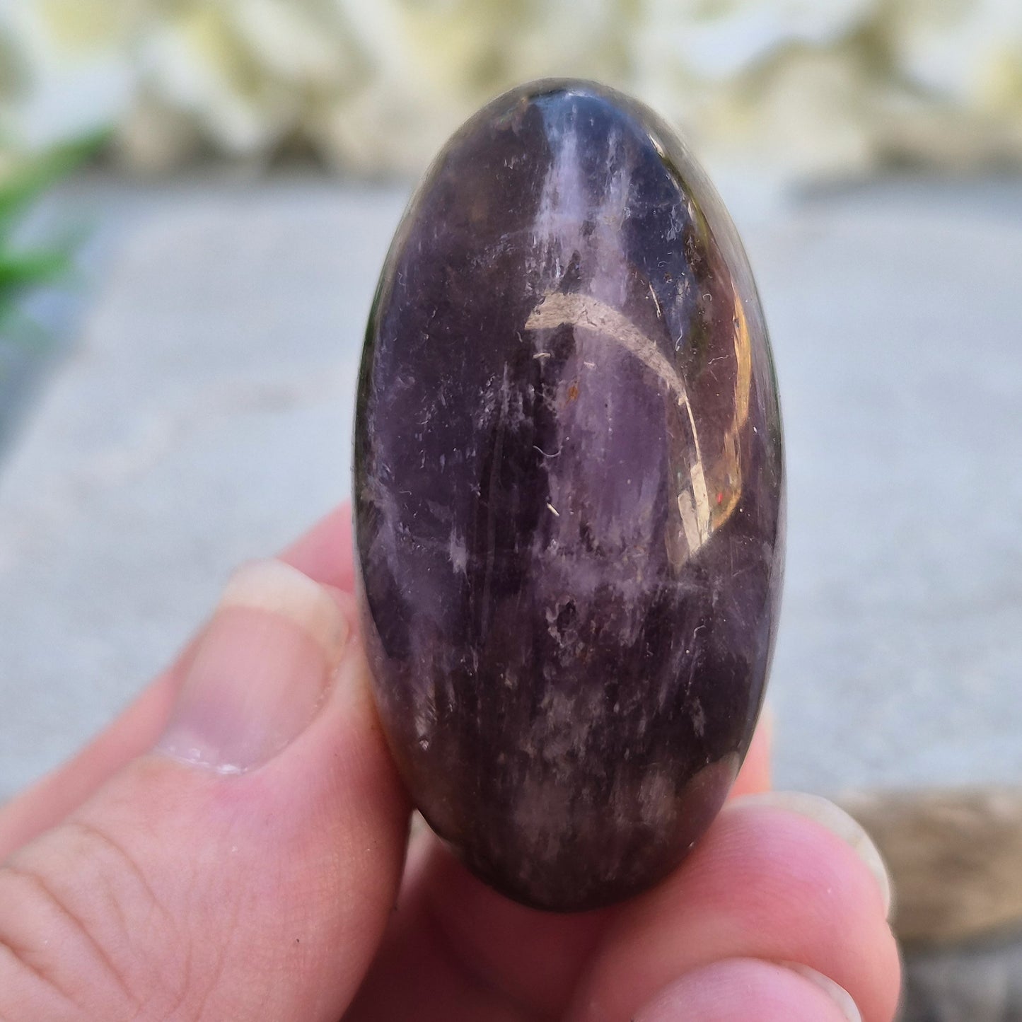 Natural Ametrine palm stone with subtle colour mix and organic inclusions. A smooth, easy-to-hold crystal for focus, balance, and direction. 