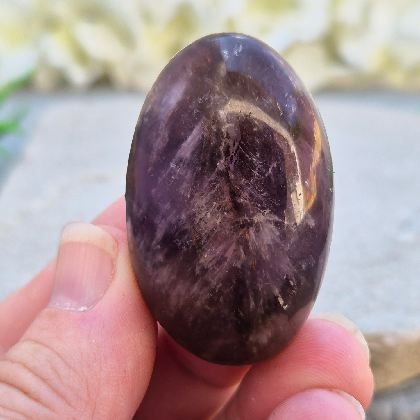 Natural Ametrine palm stone with subtle colour mix and organic inclusions. A smooth, easy-to-hold crystal for focus, balance, and direction. 