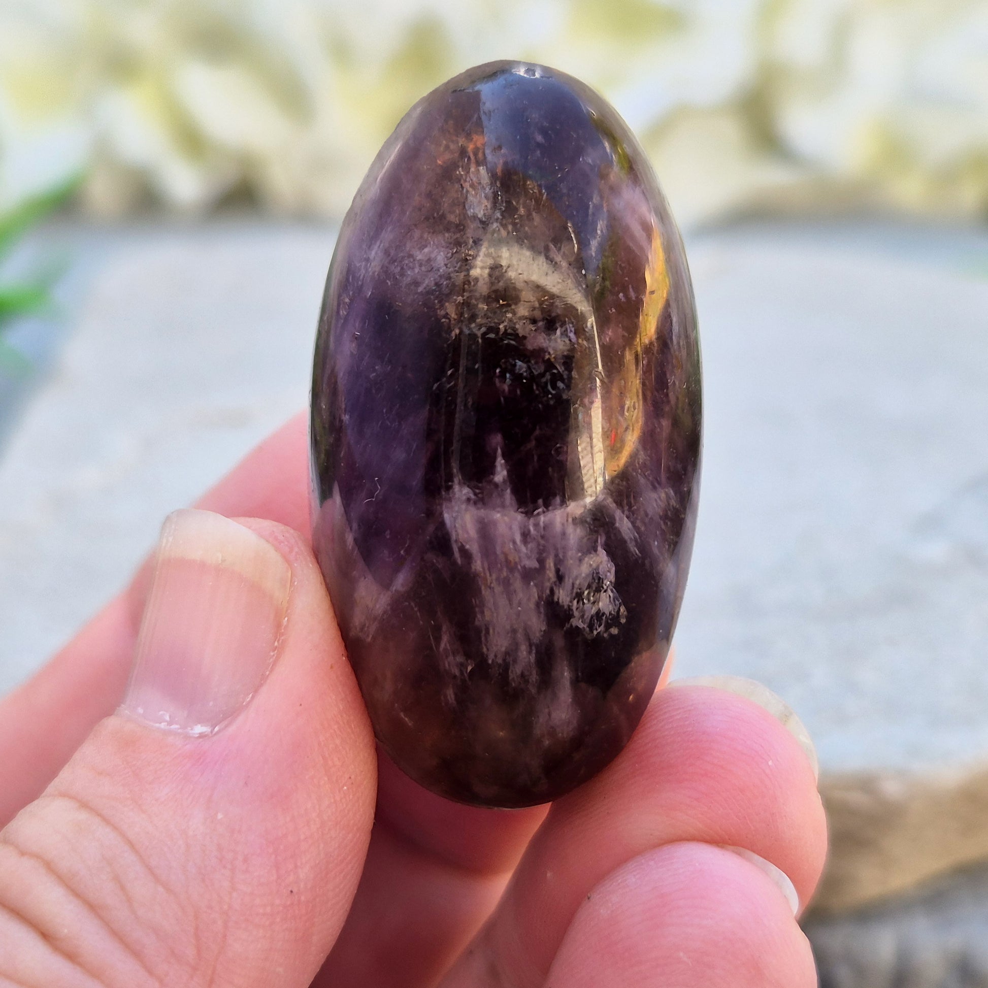 Natural Ametrine palm stone with subtle colour mix and organic inclusions. A smooth, easy-to-hold crystal for focus, balance, and direction. 
