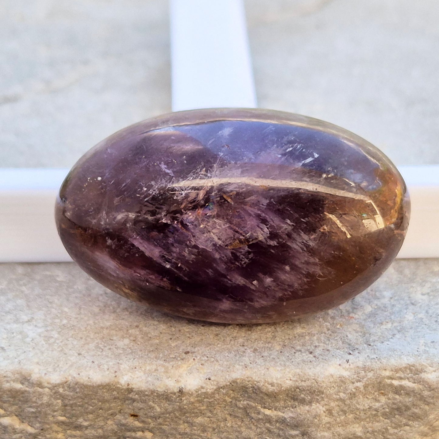Natural Ametrine palm stone with subtle colour mix and organic inclusions. A smooth, easy-to-hold crystal for focus, balance, and direction. 