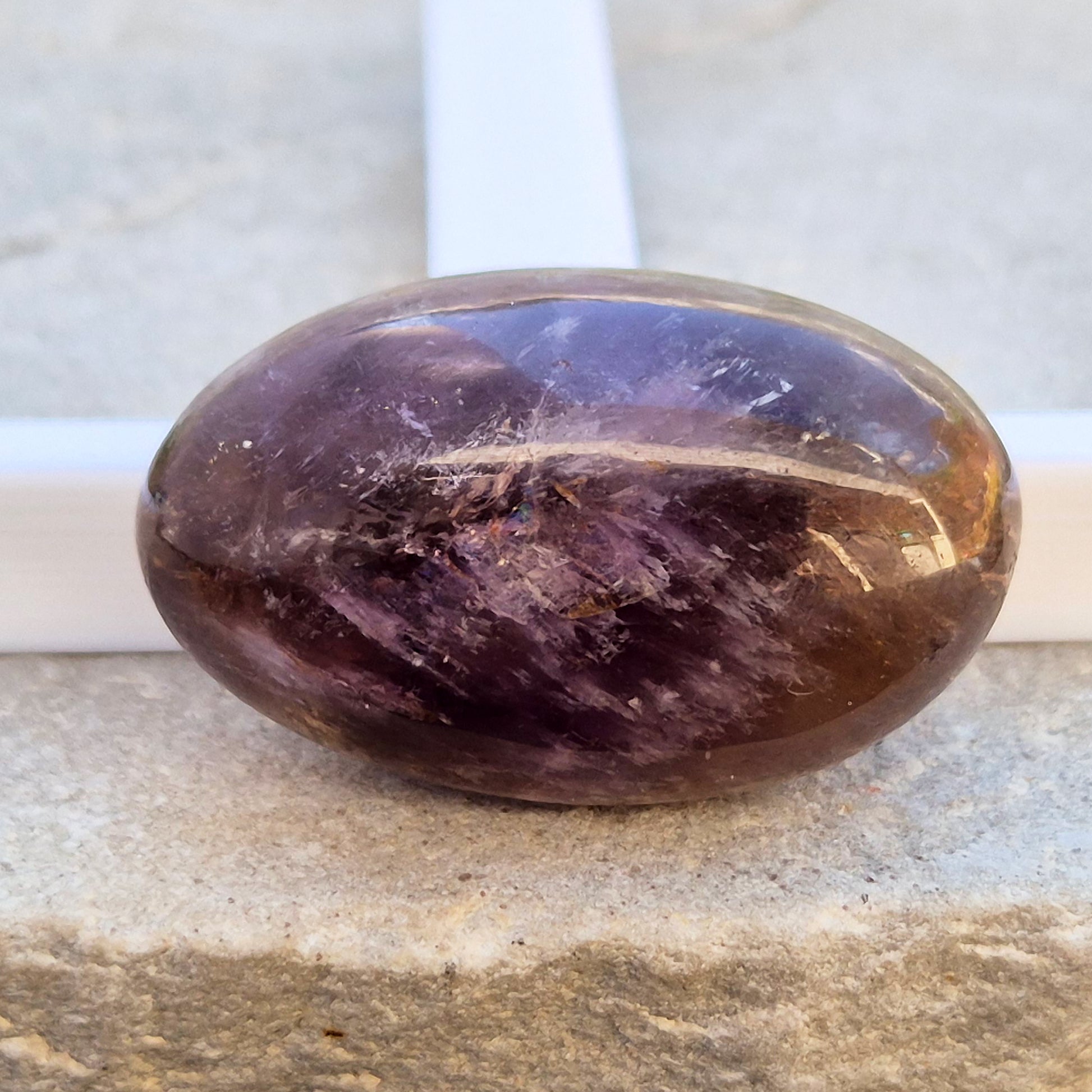 Natural Ametrine palm stone with subtle colour mix and organic inclusions. A smooth, easy-to-hold crystal for focus, balance, and direction. 