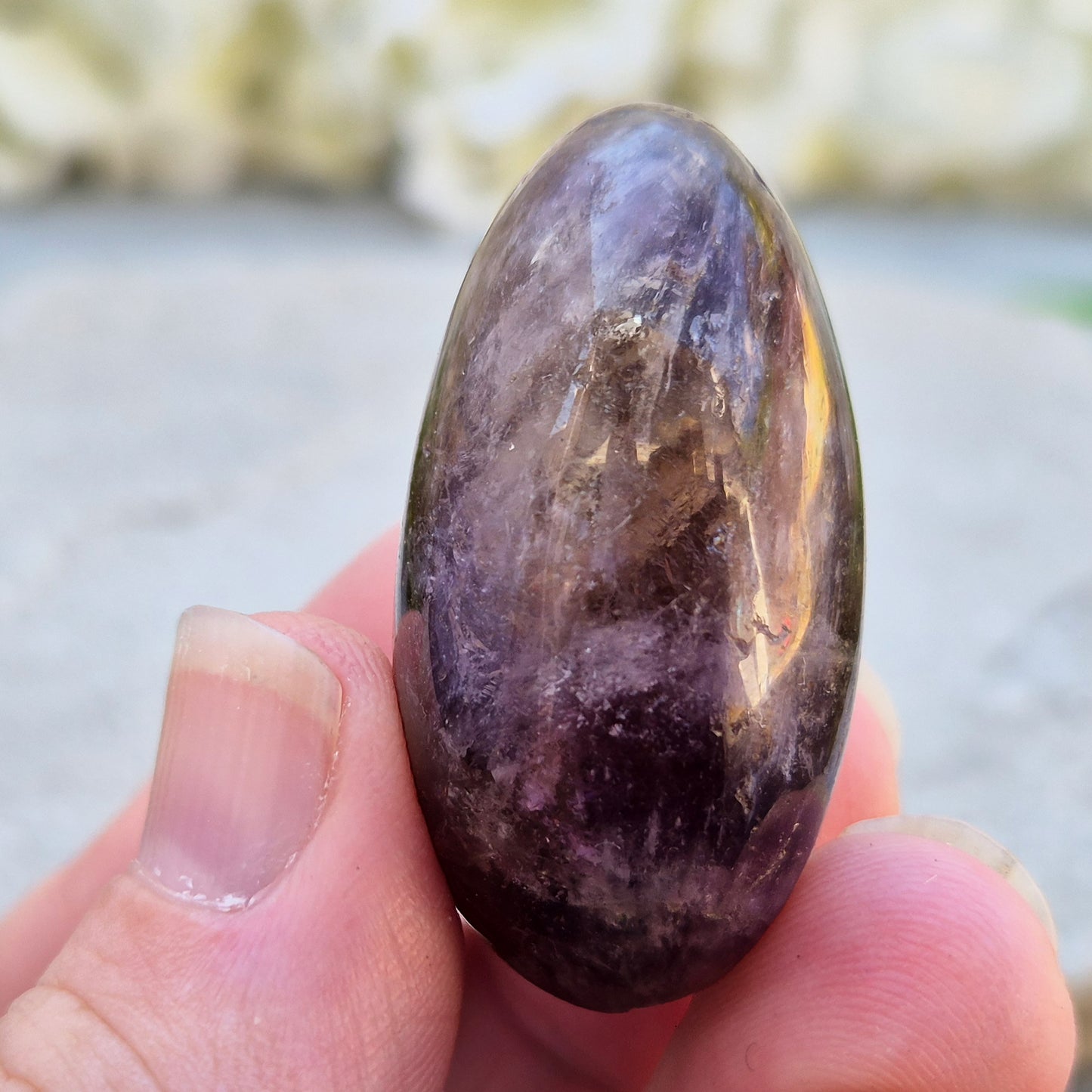 Ametrine polished palm stone with soft purple and golden tones. A natural blend of Amethyst and Citrine with a balanced, easy feel. 