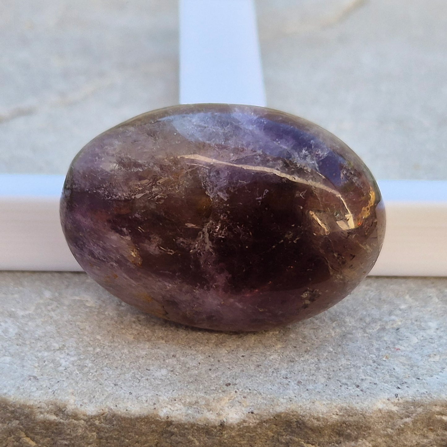 Ametrine polished palm stone with soft purple and golden tones. A natural blend of Amethyst and Citrine with a balanced, easy feel. 