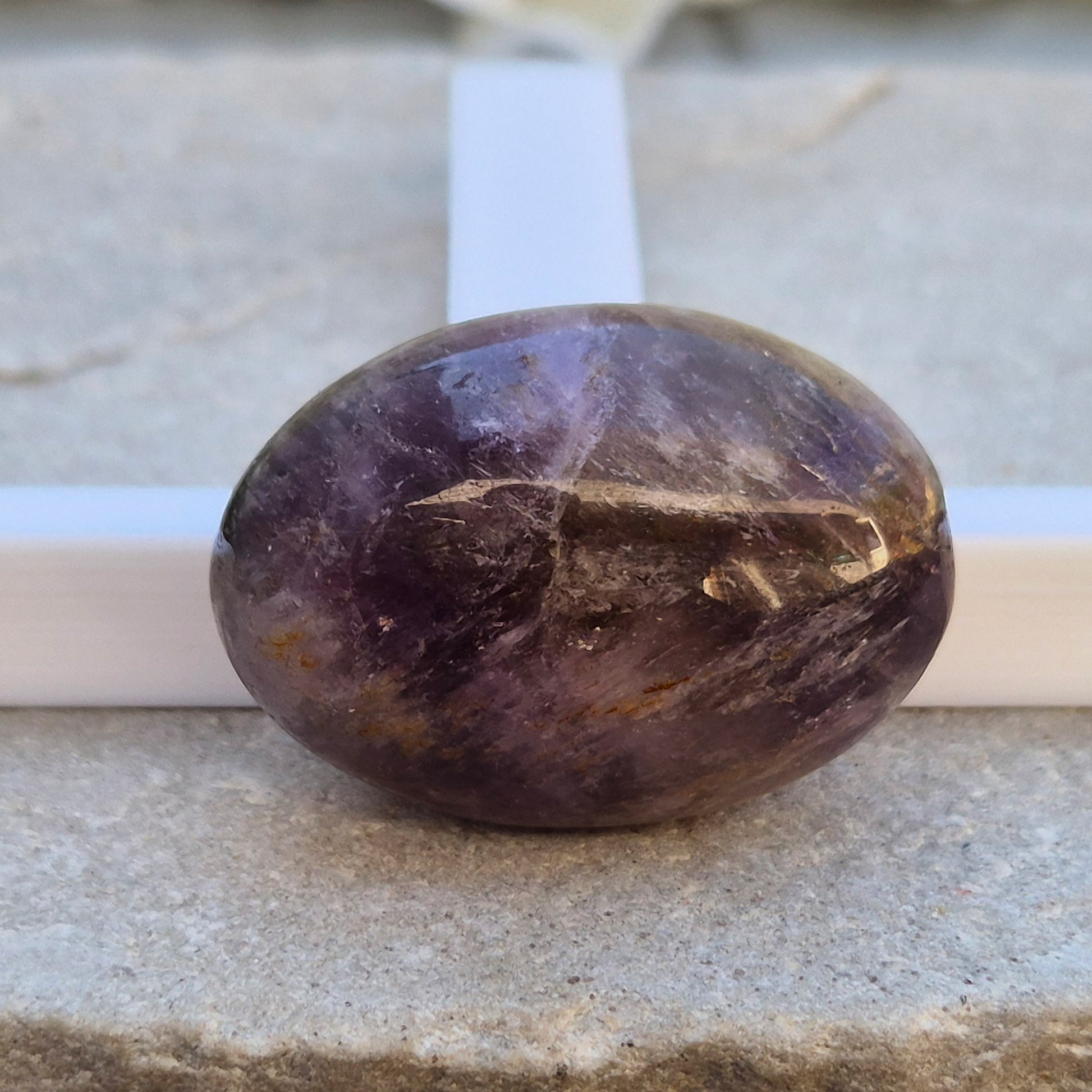 Ametrine polished palm stone with soft purple and golden tones. A natural blend of Amethyst and Citrine with a balanced, easy feel. 
