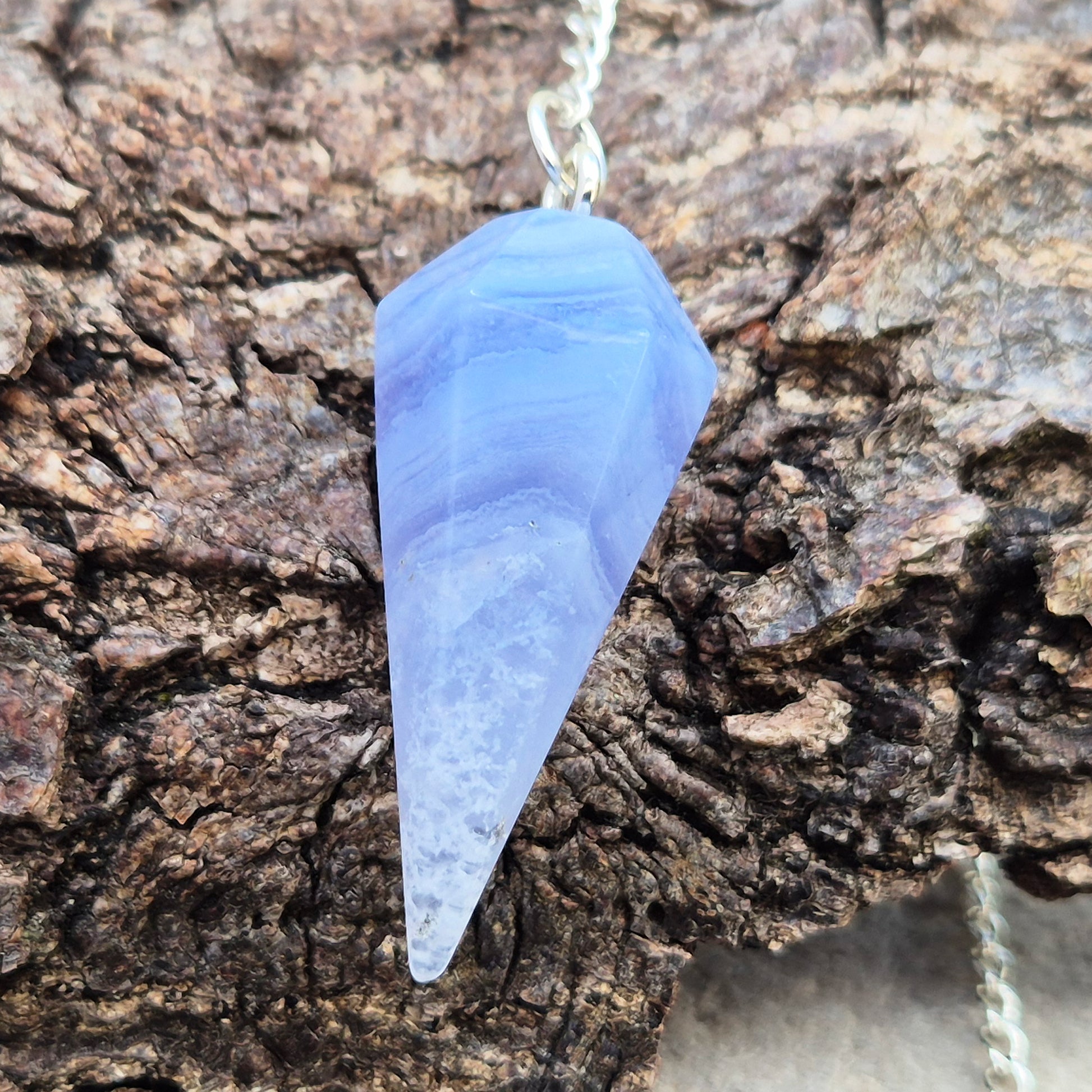 Blue Lace Agate crystal pendulum, known for its calming energy. Ideal for dowsing, spiritual guidance, and bringing a steady, peaceful feel.