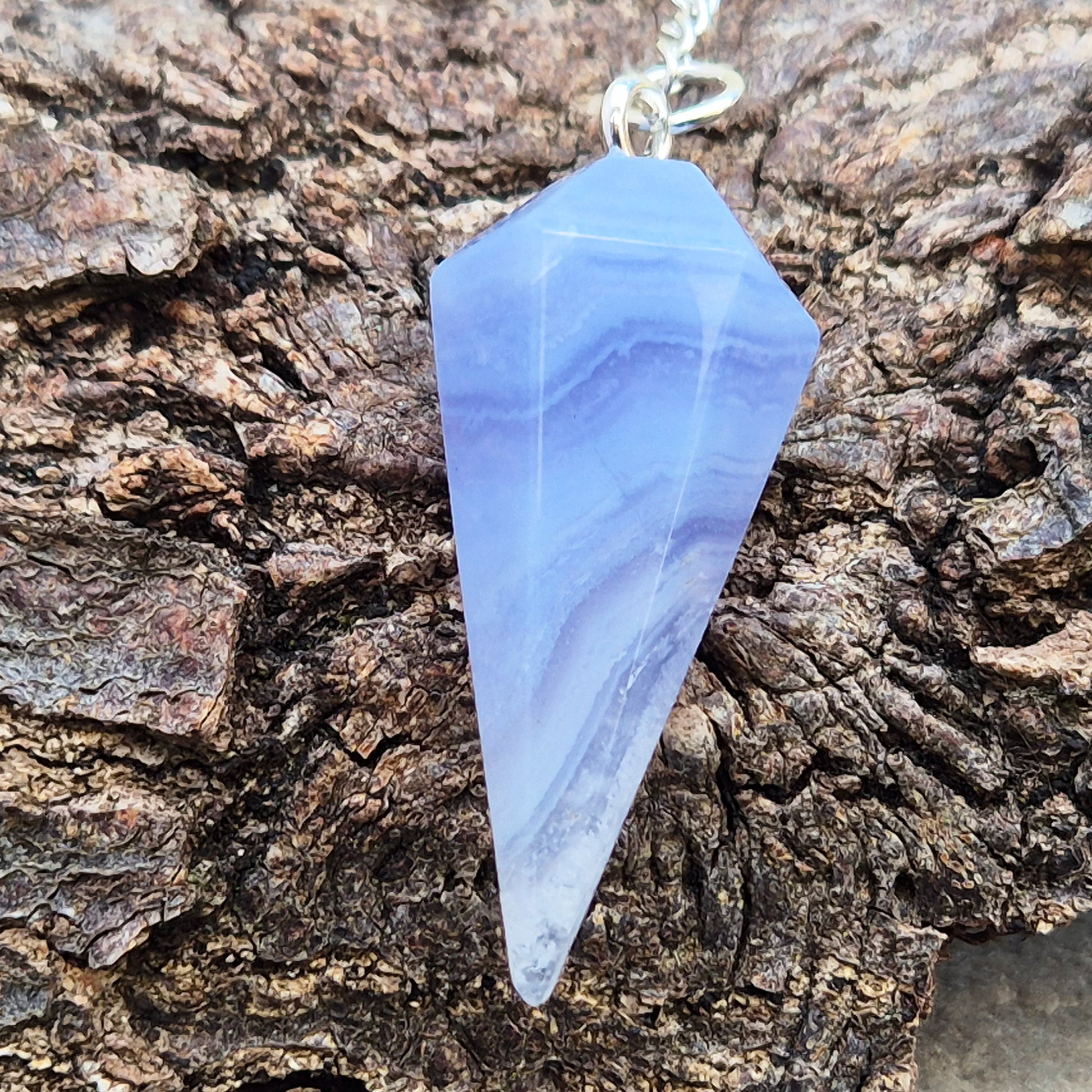 Blue Lace Agate crystal pendulum, known for its calming energy. Ideal for dowsing, spiritual guidance, and bringing a steady, peaceful feel.