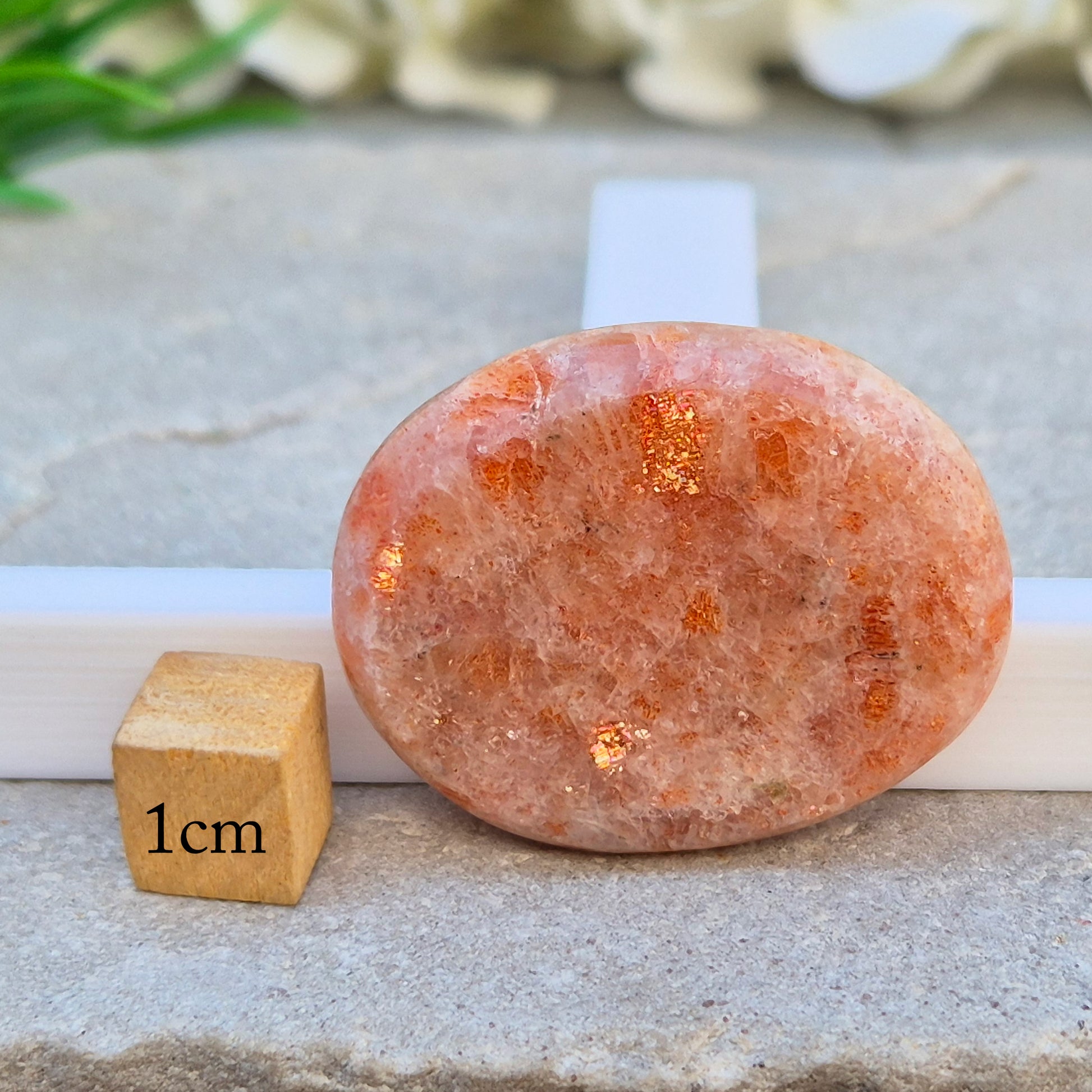 This flat, oval Sunstone palm stone carries soft peachy-orange tones and sits smoothly in the hand. Small enough to slip into a pocket or bag — sunshine you can carry with you.