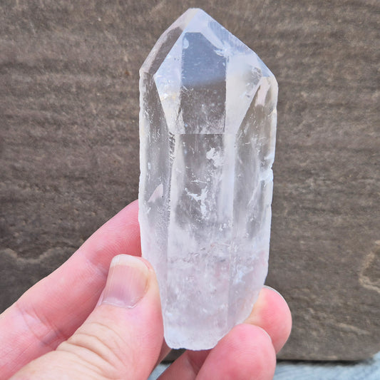 This Natural Quartz Crystal Point comes from Brazil and has a nice clear transparent tip and some interesting markings on one side.