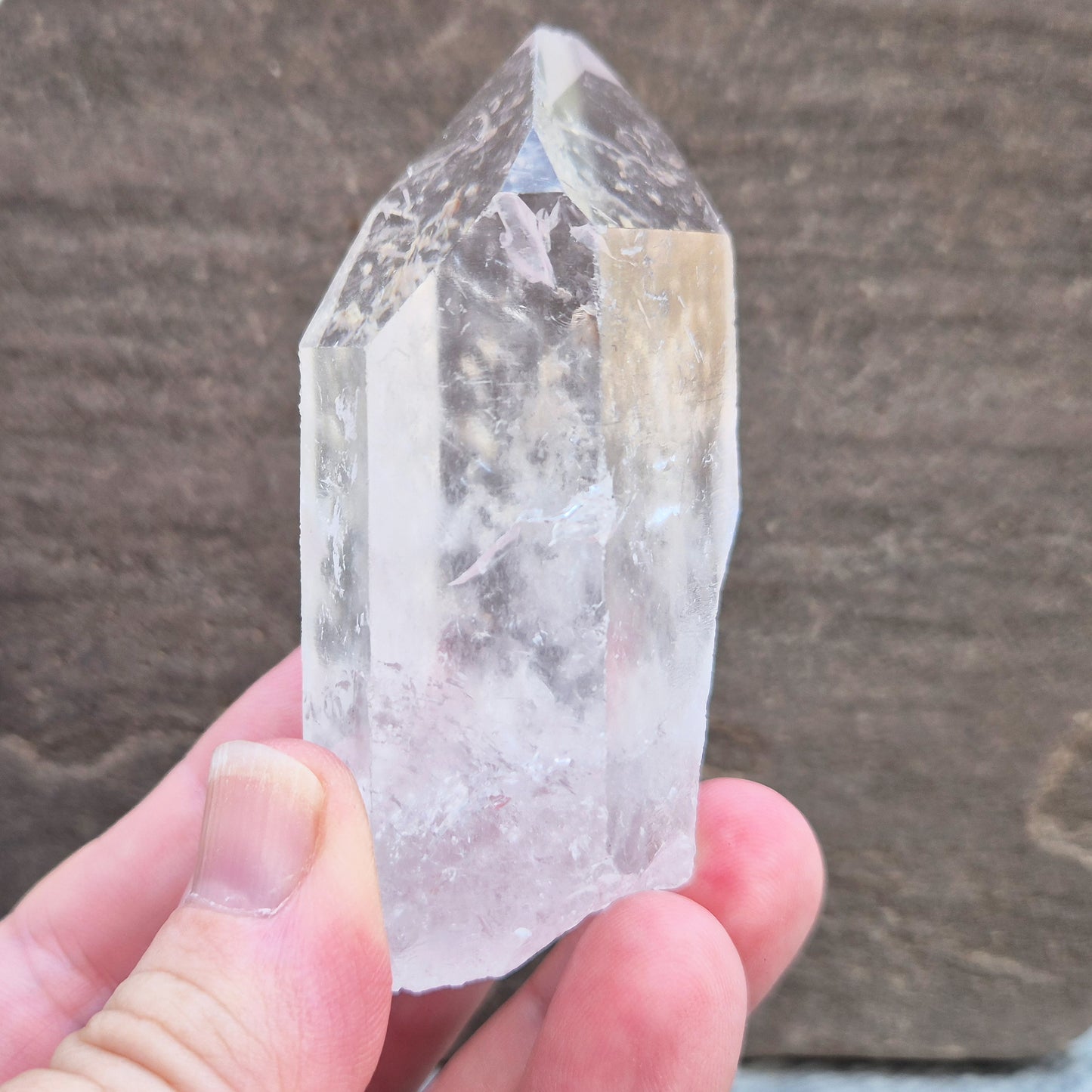 This Natural Quartz Crystal Point comes from Brazil and has a nice clear transparent tip and some interesting markings on one side.