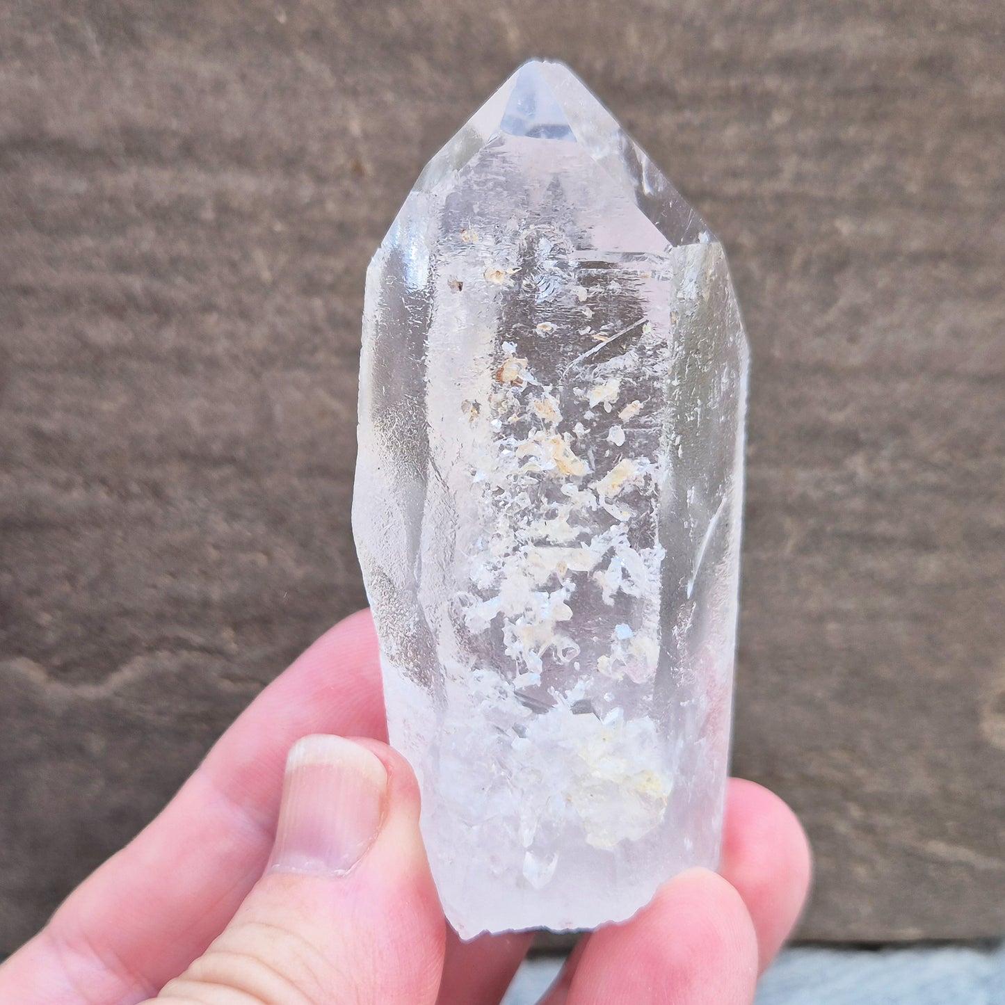 This Natural Quartz Crystal Point comes from Brazil and has a nice clear transparent tip and some interesting markings on one side.