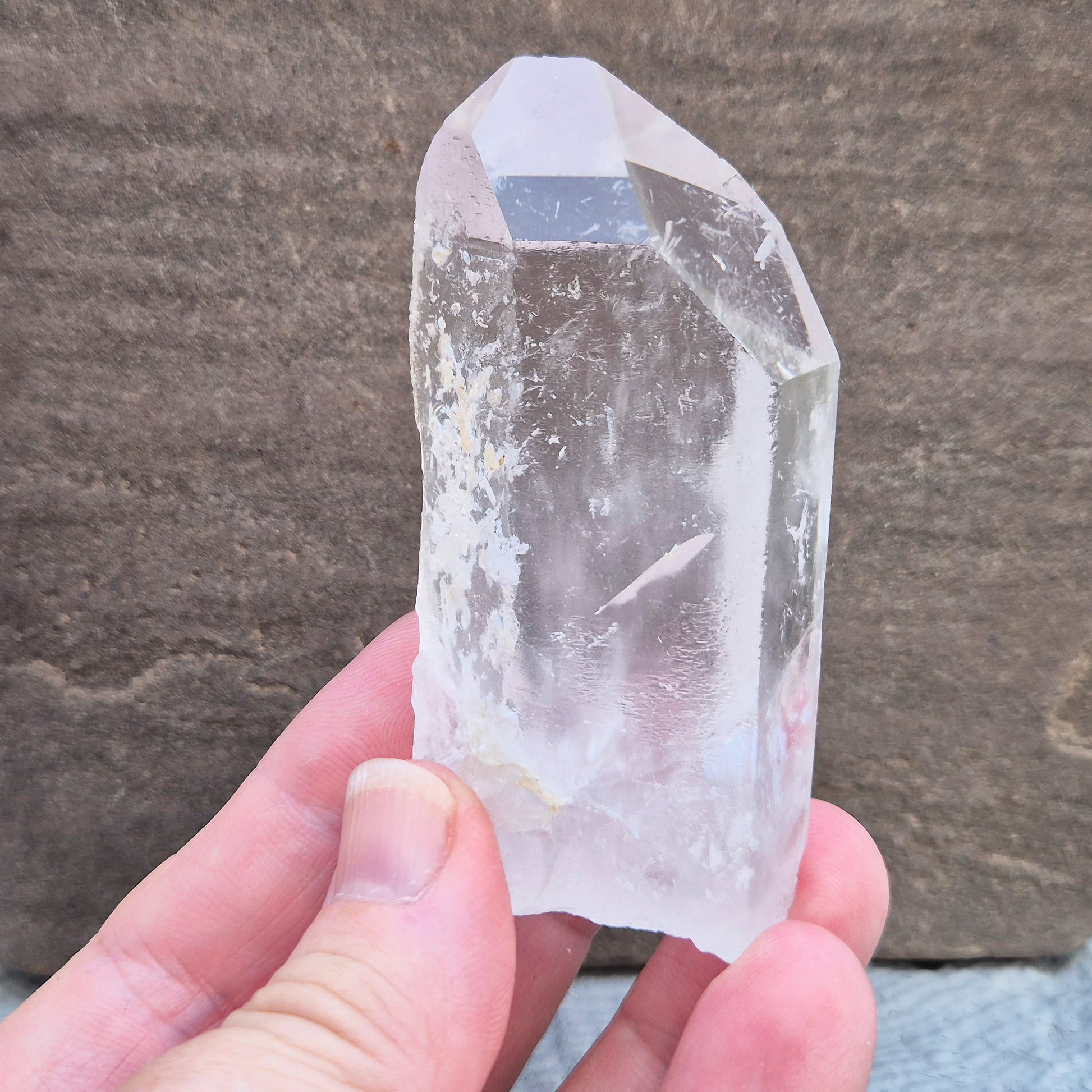 This Natural Quartz Crystal Point comes from Brazil and has a nice clear transparent tip and some interesting markings on one side.