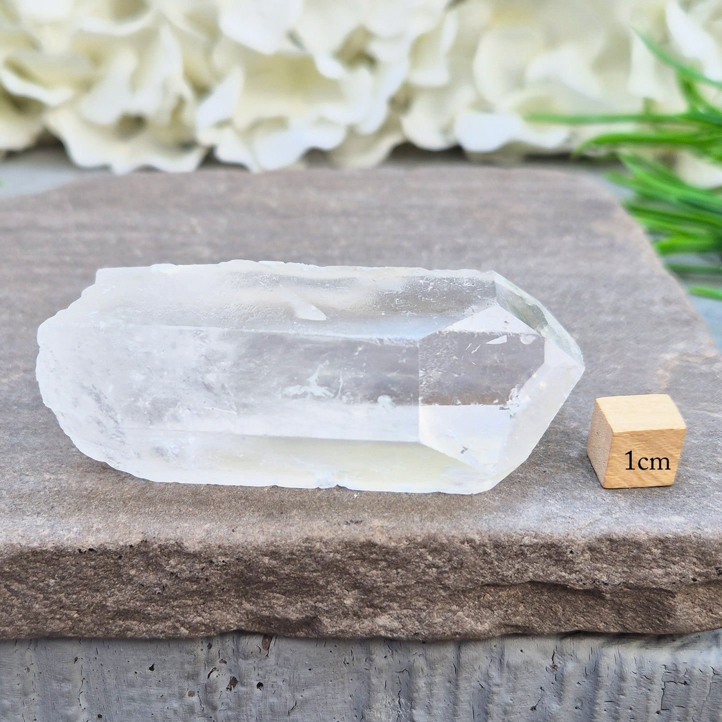 This Natural Quartz Crystal Point comes from Brazil and has a nice clear transparent tip and some interesting markings on one side.