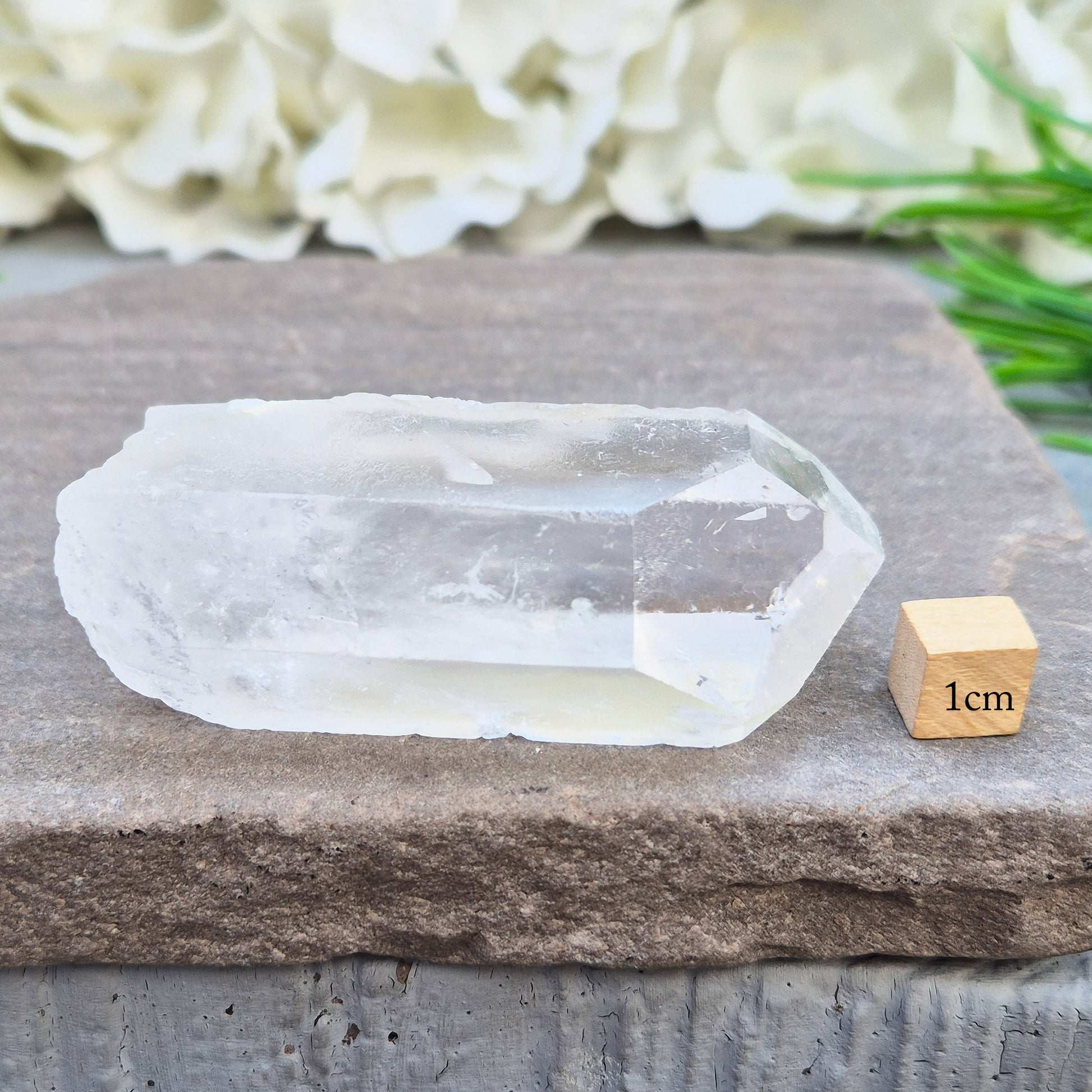 This Natural Quartz Crystal Point comes from Brazil and has a nice clear transparent tip and some interesting markings on one side.