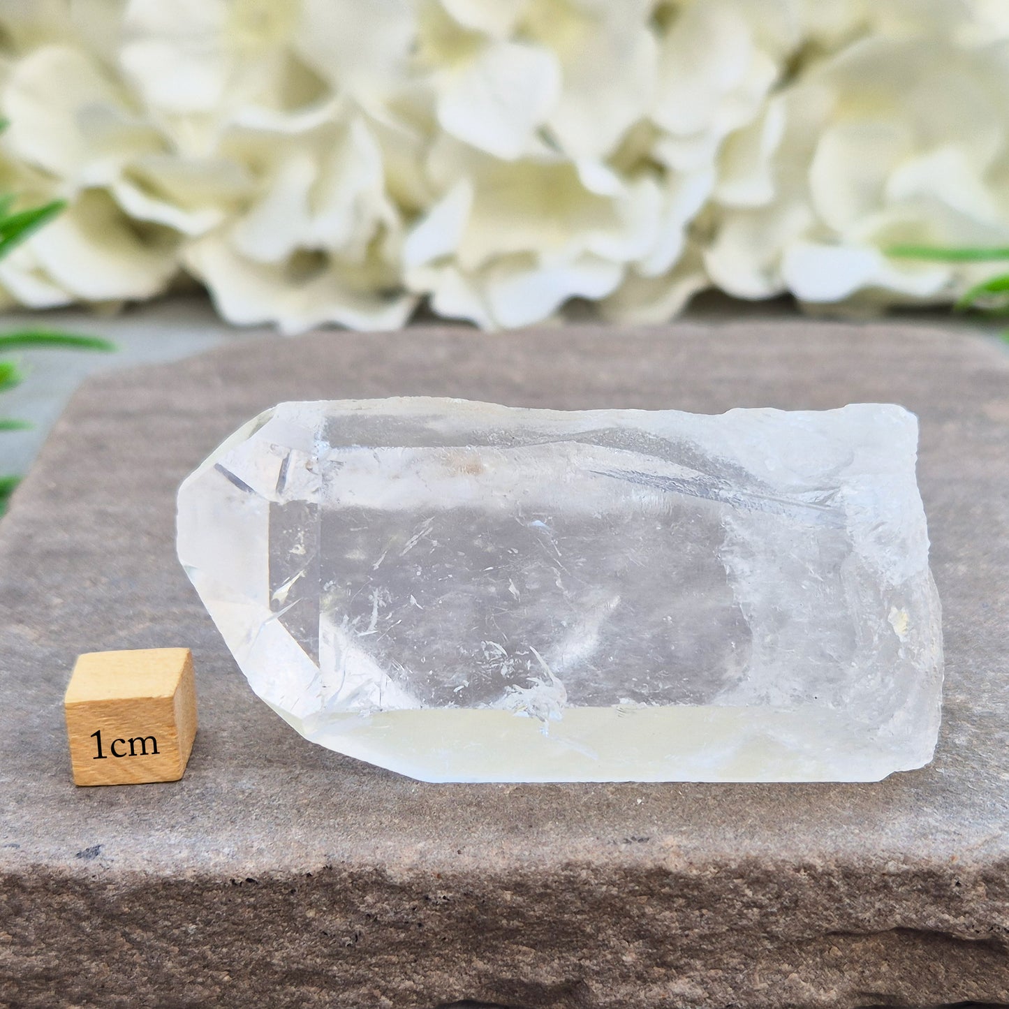 This Natural Quartz Crystal Point comes from Brazil and has a nice clear transparent tip and some interesting markings on one side.