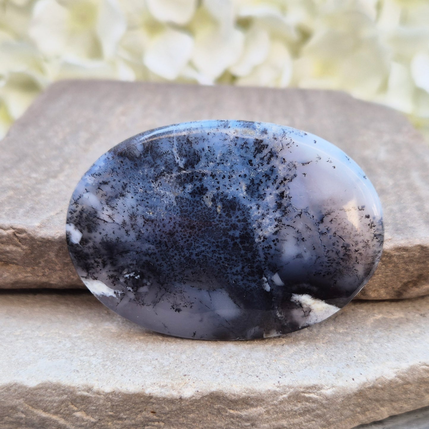 Merlinite Palm Stone - a grounding and intuitive crystal for meditation, inner balance and spiritual work. Smooth pocket stone for daily calm energy.