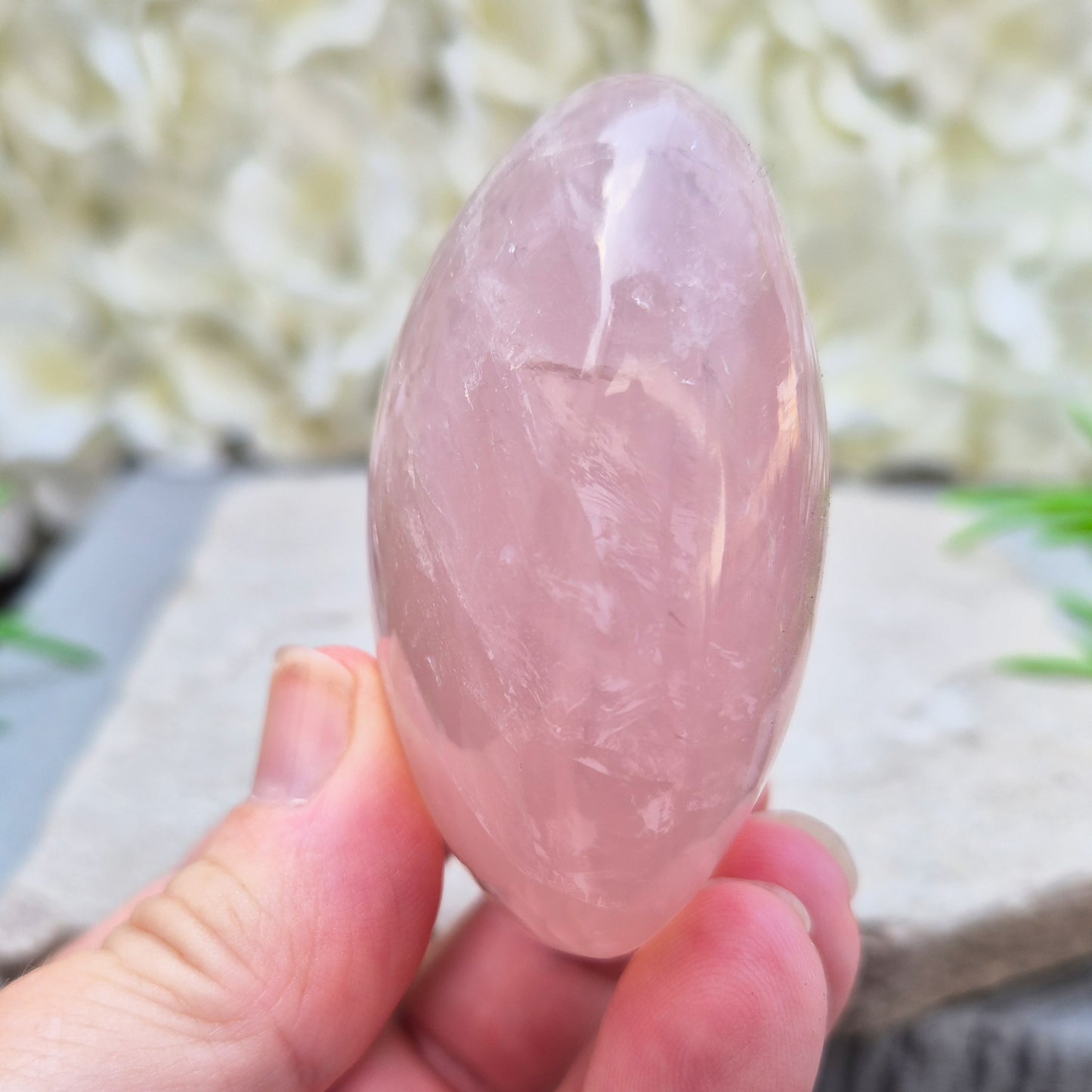 Large polished Rose Quartz palm stone with soft pink colouring and a smooth, rounded shape designed to sit naturally and comfortably in the hand.
