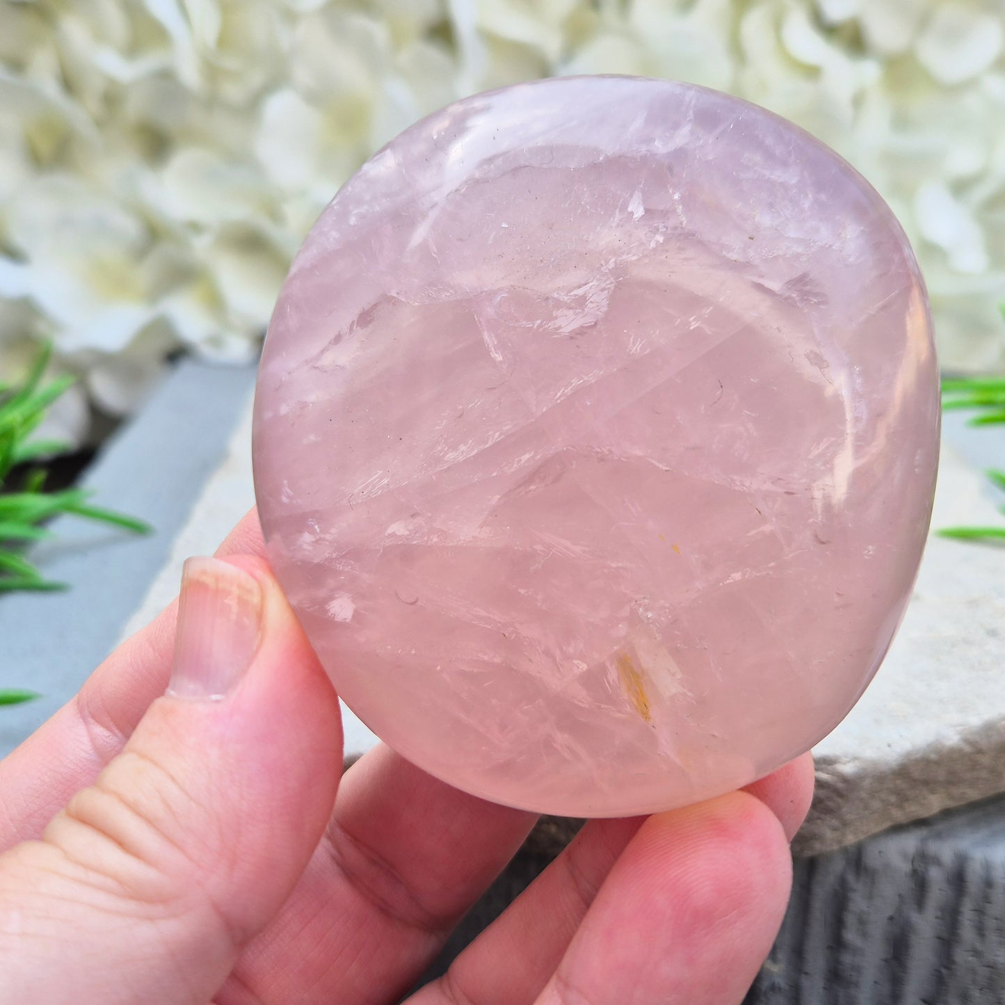 Large polished Rose Quartz palm stone with soft pink colouring and a smooth, rounded shape designed to sit naturally and comfortably in the hand.